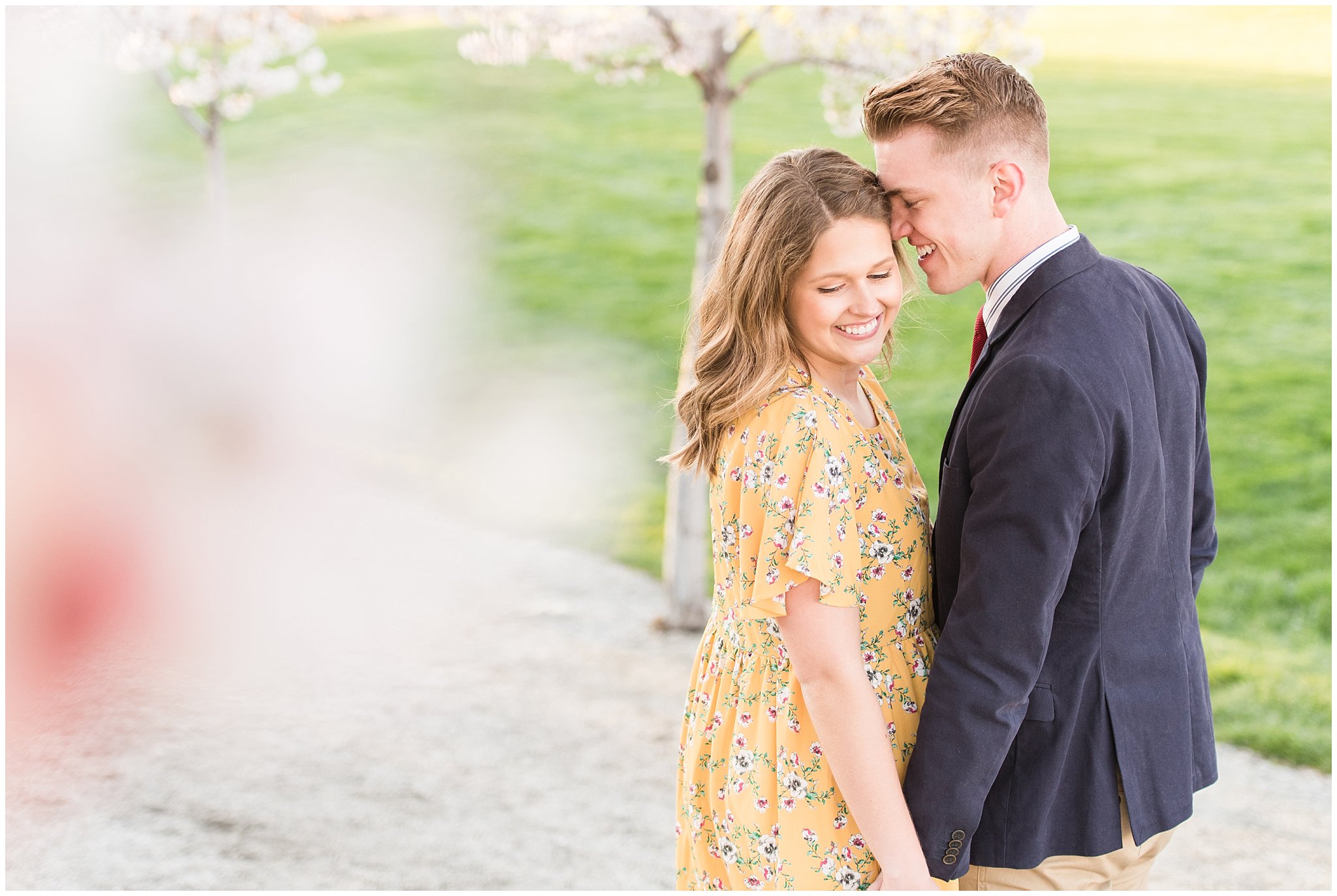 Couple dressed up in suit and yellow dress in the cherry blossoms | Spring Blossom Engagement at the Utah State Capitol | Utah Wedding Photographers | Jessie and Dallin