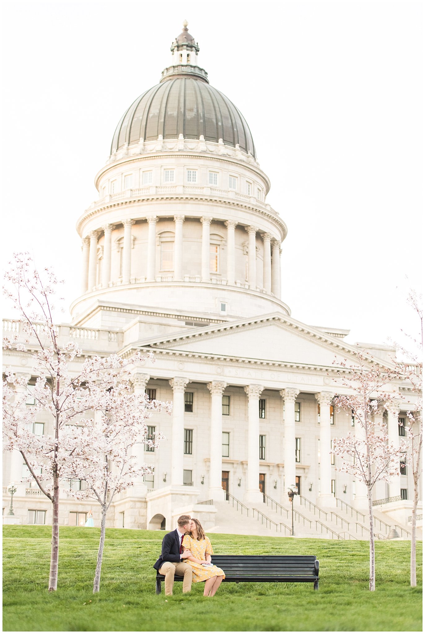 Couple dressed up in suit and yellow dress in the cherry blossoms | Spring Blossom Engagement at the Utah State Capitol | Utah Wedding Photographers | Jessie and Dallin