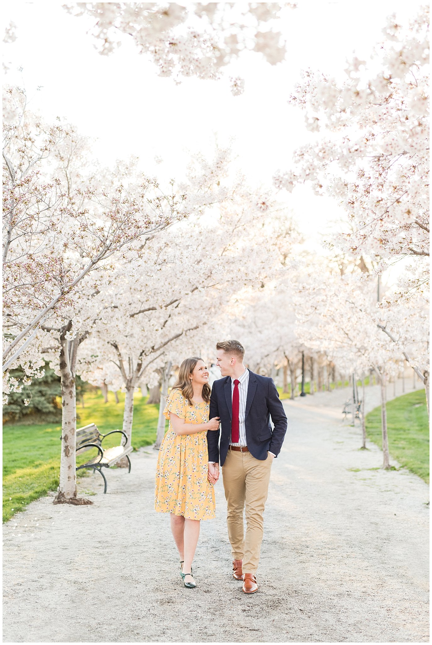 Couple dressed up in suit and yellow dress in the cherry blossoms | Spring Blossom Engagement at the Utah State Capitol | Utah Wedding Photographers | Jessie and Dallin