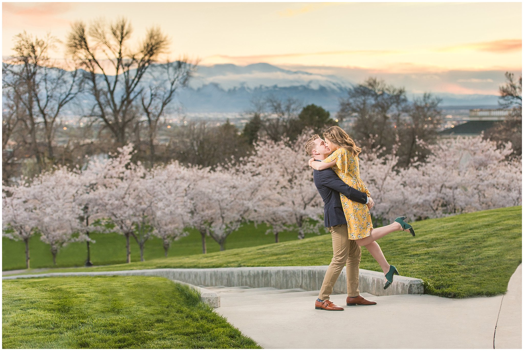 Romantic engagement with couple dressed up in suit and yellow dress in the cherry blossoms at sunset | Spring Blossom Engagement at the Utah State Capitol | Utah Wedding Photographers | Jessie and Dallin