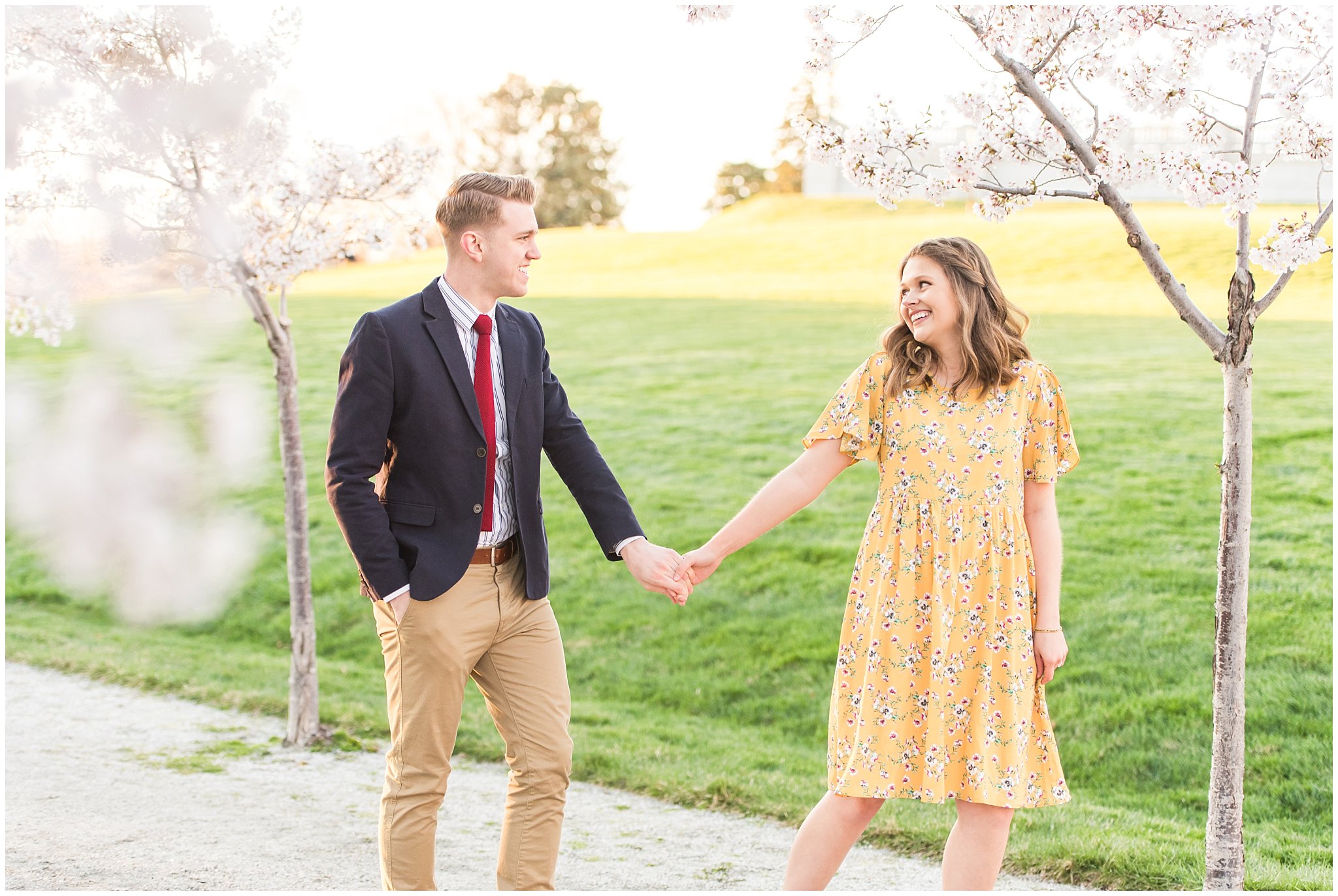 Couple dressed up in suit and yellow dress in the cherry blossoms | Spring Blossom Engagement at the Utah State Capitol | Utah Wedding Photographers | Jessie and Dallin