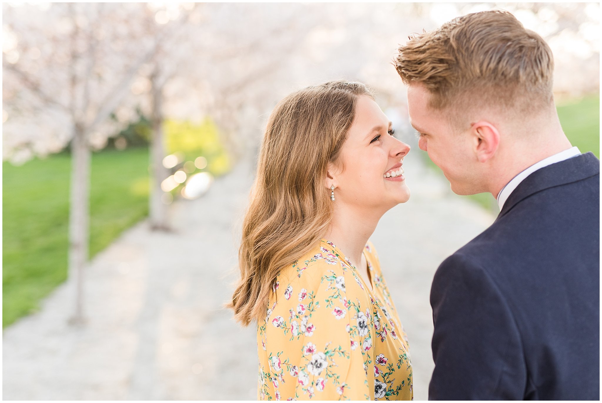 Couple dressed up in suit and yellow dress in the cherry blossoms | Spring Blossom Engagement at the Utah State Capitol | Utah Wedding Photographers | Jessie and Dallin