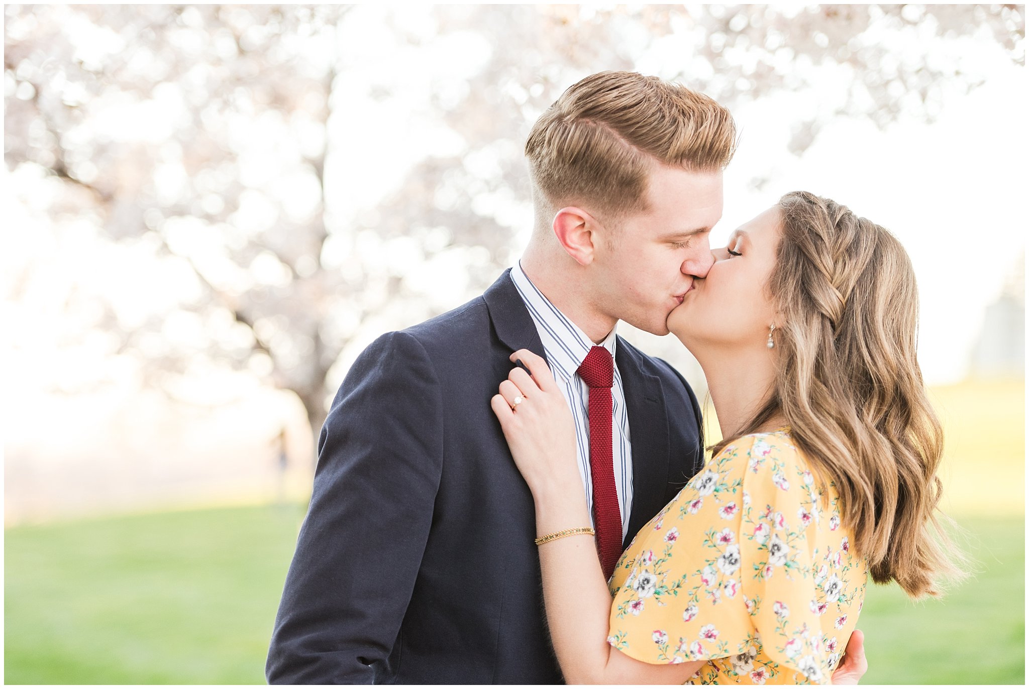 Couple dressed up in suit and yellow dress in the cherry blossoms | Spring Blossom Engagement at the Utah State Capitol | Utah Wedding Photographers | Jessie and Dallin