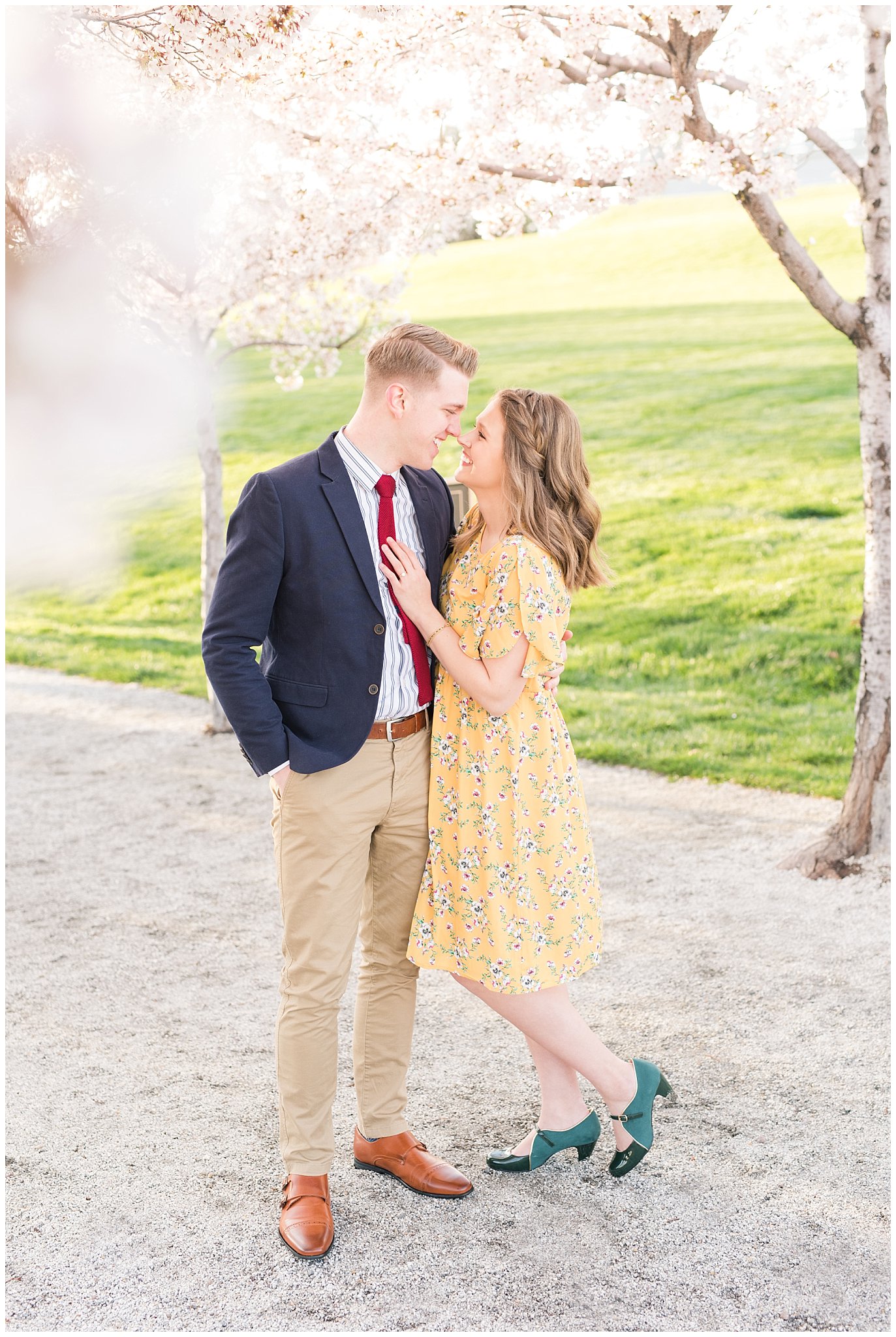 Couple dressed up in suit and yellow dress in the cherry blossoms | Spring Blossom Engagement at the Utah State Capitol | Utah Wedding Photographers | Jessie and Dallin