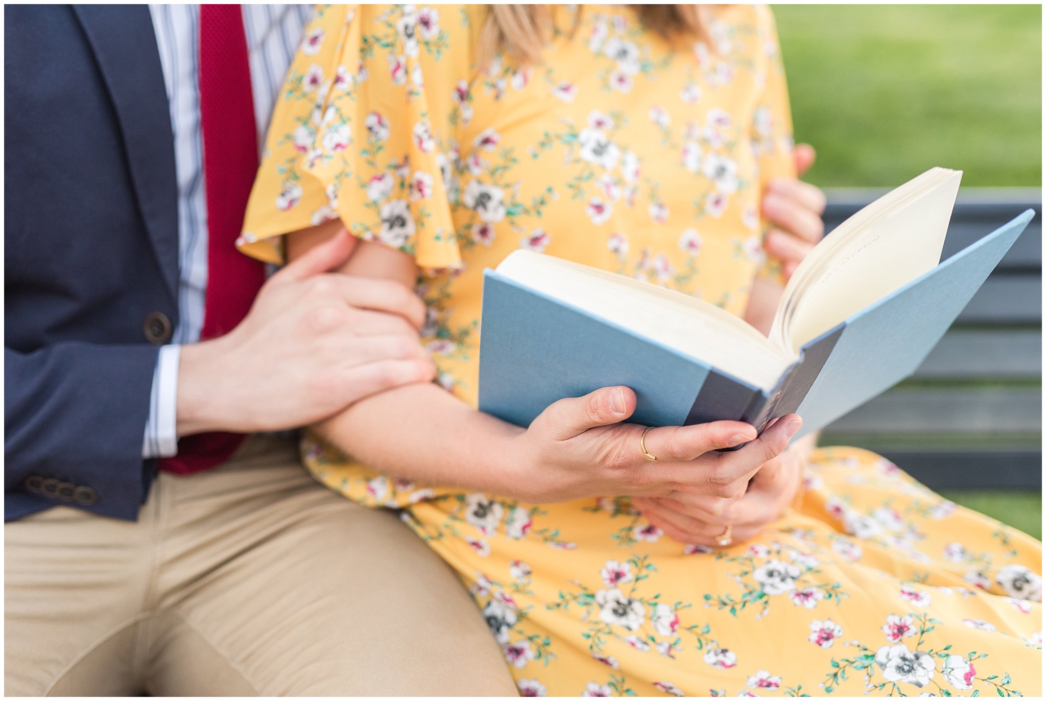 Couple dressed up and reading a book in suit and yellow dress in the cherry blossoms | Spring Blossom Engagement at the Utah State Capitol | Utah Wedding Photographers | Jessie and Dallin