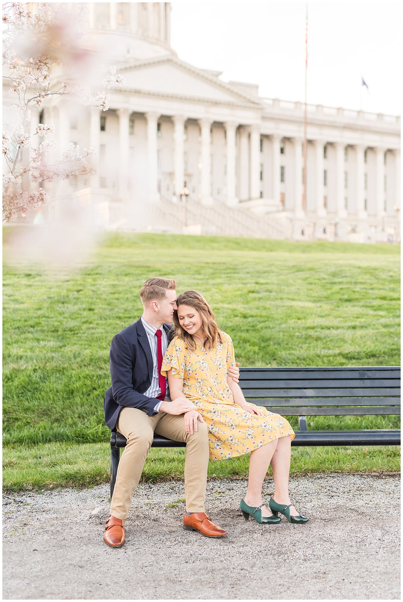 Couple dressed up in suit and yellow dress in the cherry blossoms | Spring Blossom Engagement at the Utah State Capitol | Utah Wedding Photographers | Jessie and Dallin