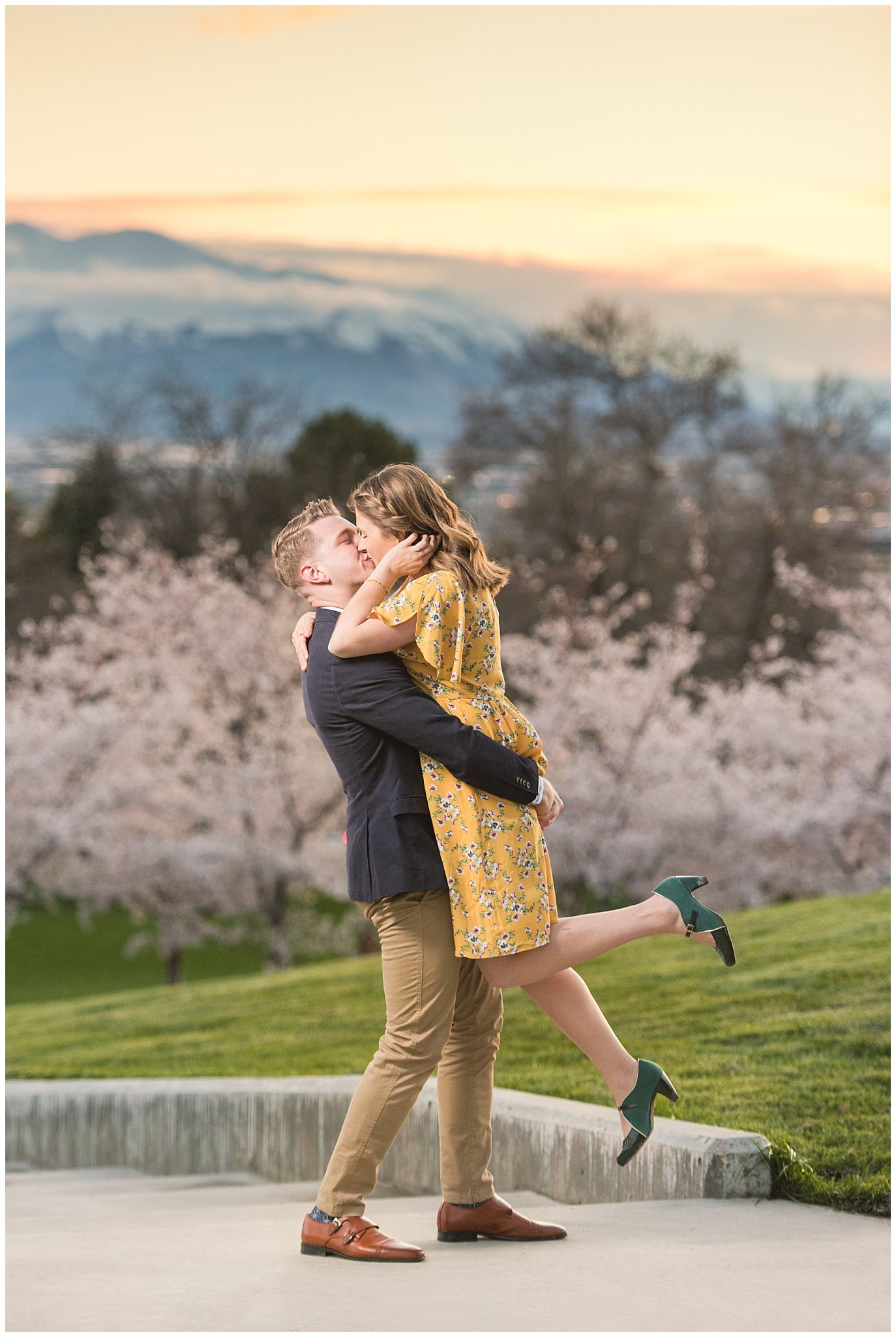 Romantic engagement with couple dressed up in suit and yellow dress in the cherry blossoms at sunset | Spring Blossom Engagement at the Utah State Capitol | Utah Wedding Photographers | Jessie and Dallin