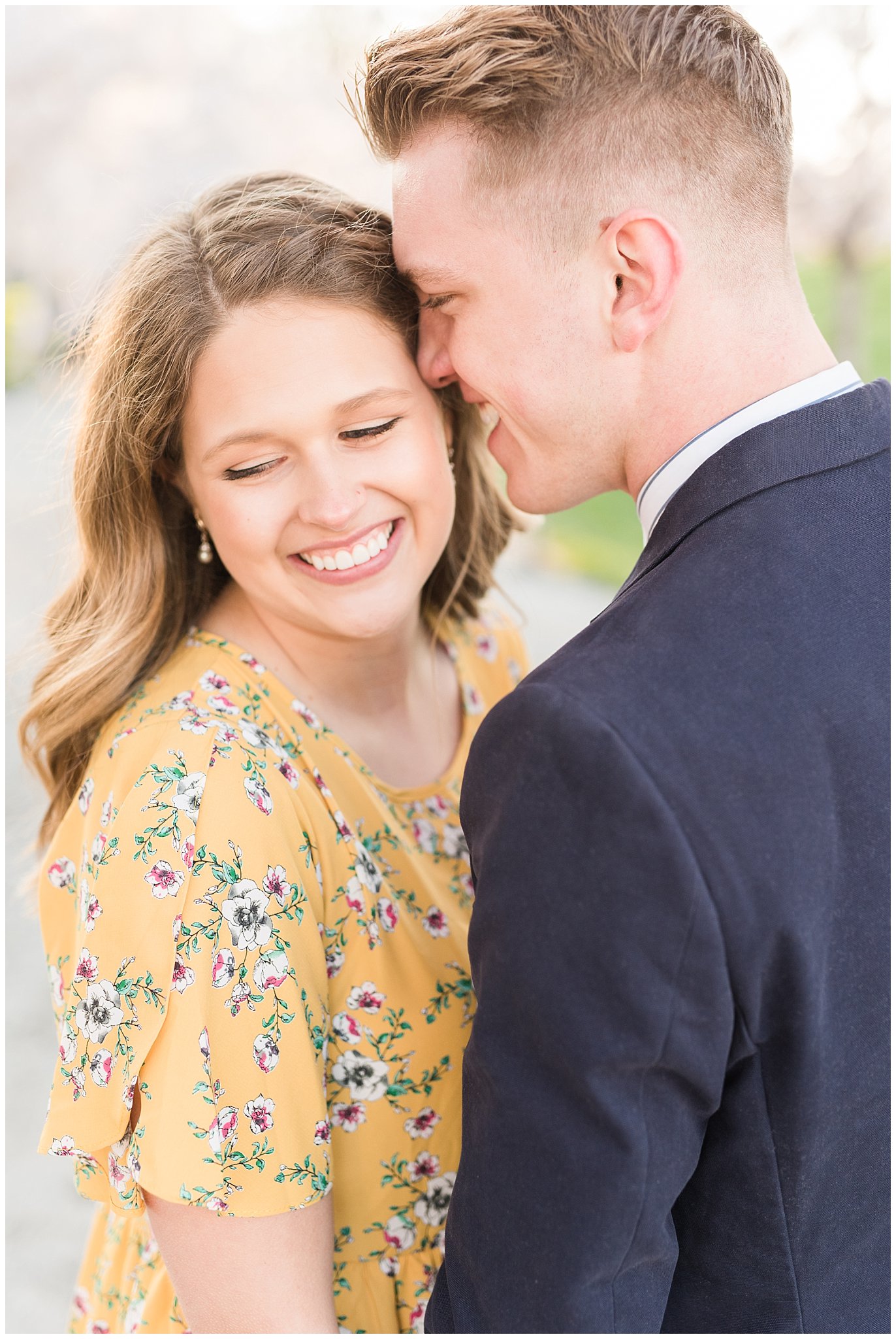 Couple dressed up in suit and yellow dress in the cherry blossoms | Spring Blossom Engagement at the Utah State Capitol | Utah Wedding Photographers | Jessie and Dallin