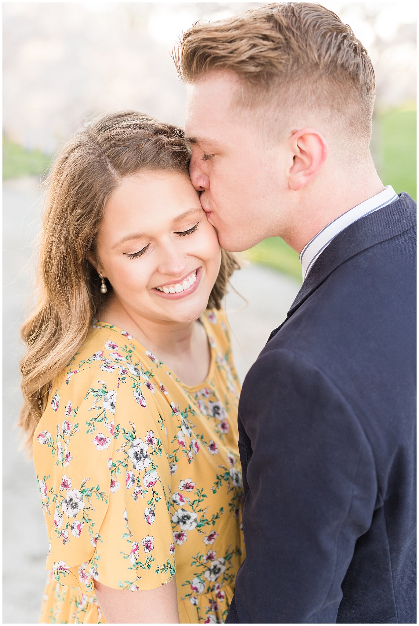 Couple dressed up in suit and yellow dress in the cherry blossoms | Spring Blossom Engagement at the Utah State Capitol | Utah Wedding Photographers | Jessie and Dallin