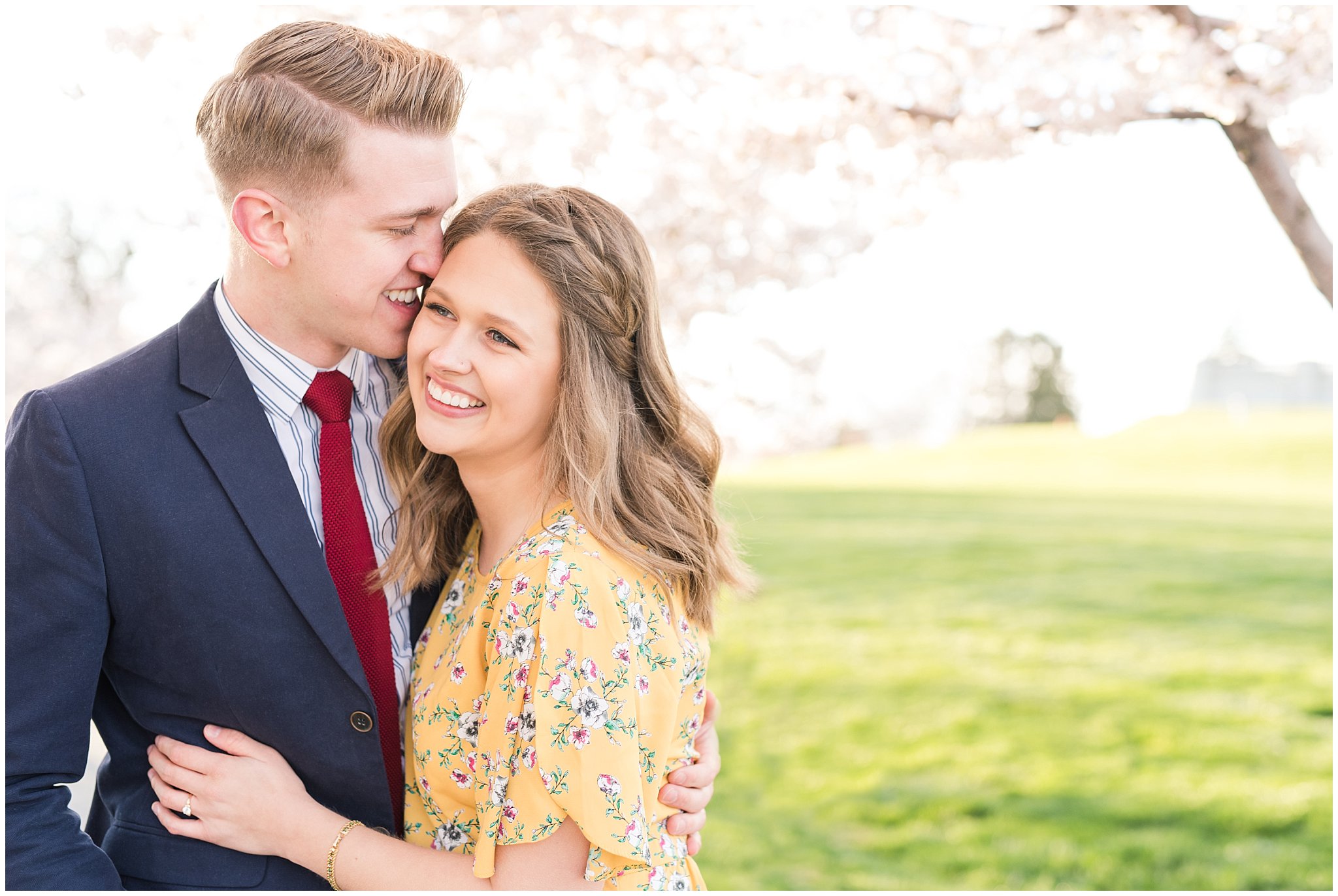 Couple dressed up in suit and yellow dress in the cherry blossoms | Spring Blossom Engagement at the Utah State Capitol | Utah Wedding Photographers | Jessie and Dallin