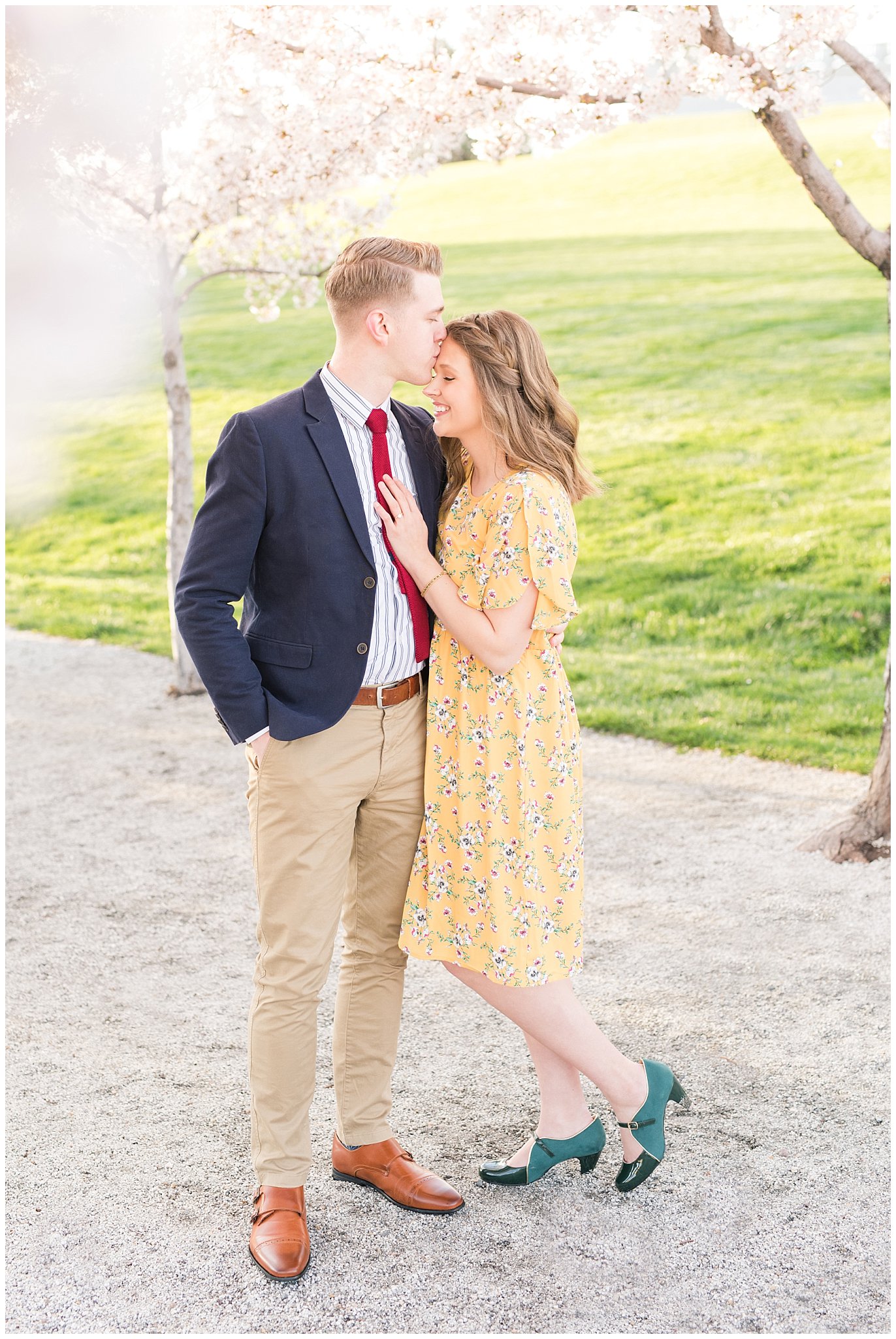 Couple dressed up in suit and yellow dress in the cherry blossoms | Spring Blossom Engagement at the Utah State Capitol | Utah Wedding Photographers | Jessie and Dallin