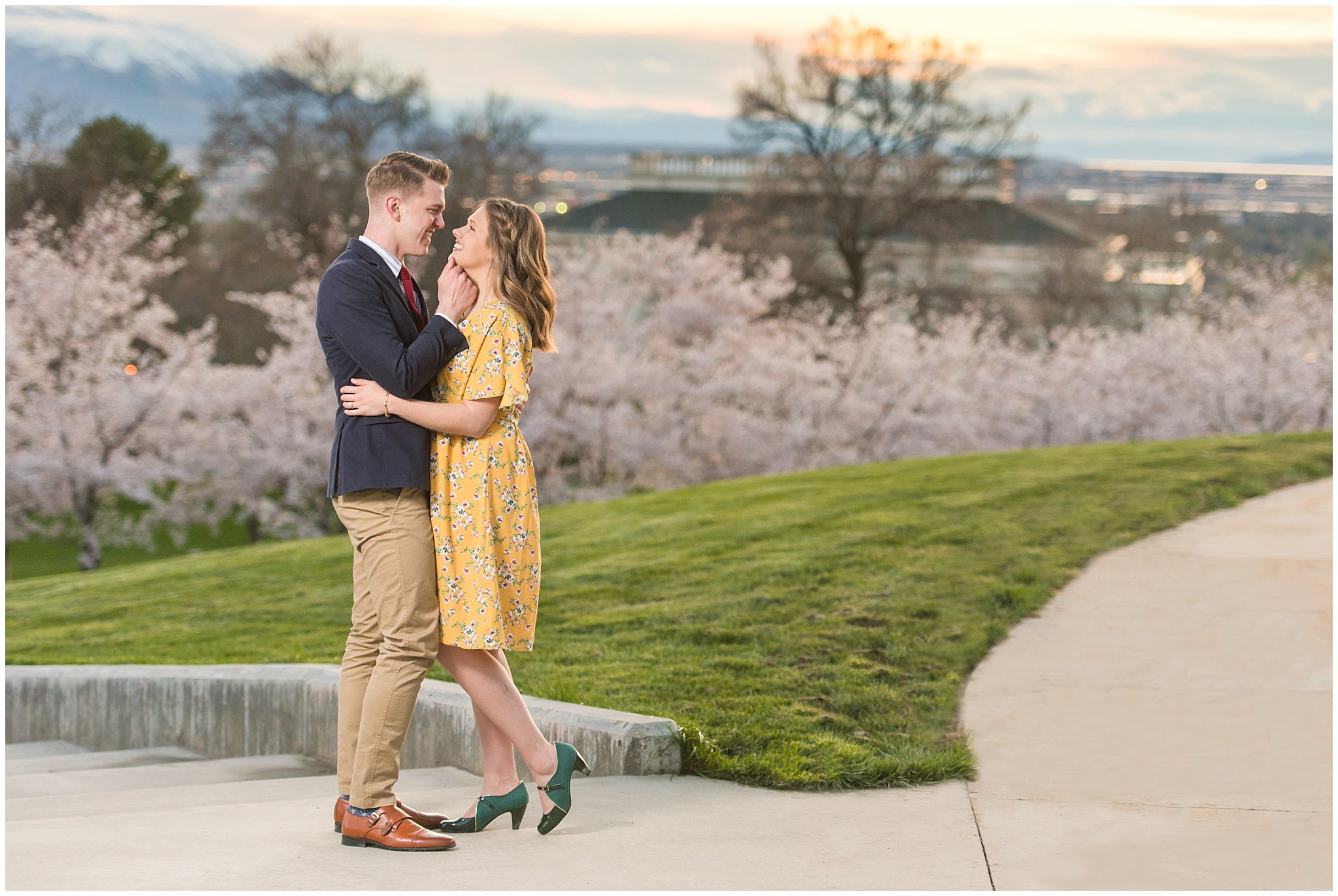 Romantic engagement with couple dressed up in suit and yellow dress in the cherry blossoms at sunset | Spring Blossom Engagement at the Utah State Capitol | Utah Wedding Photographers | Jessie and Dallin