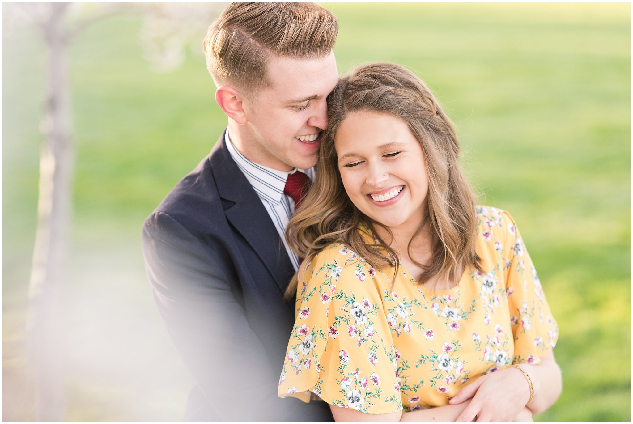 Couple dressed up in suit and yellow dress in the cherry blossoms | Spring Blossom Engagement at the Utah State Capitol | Utah Wedding Photographers | Jessie and Dallin