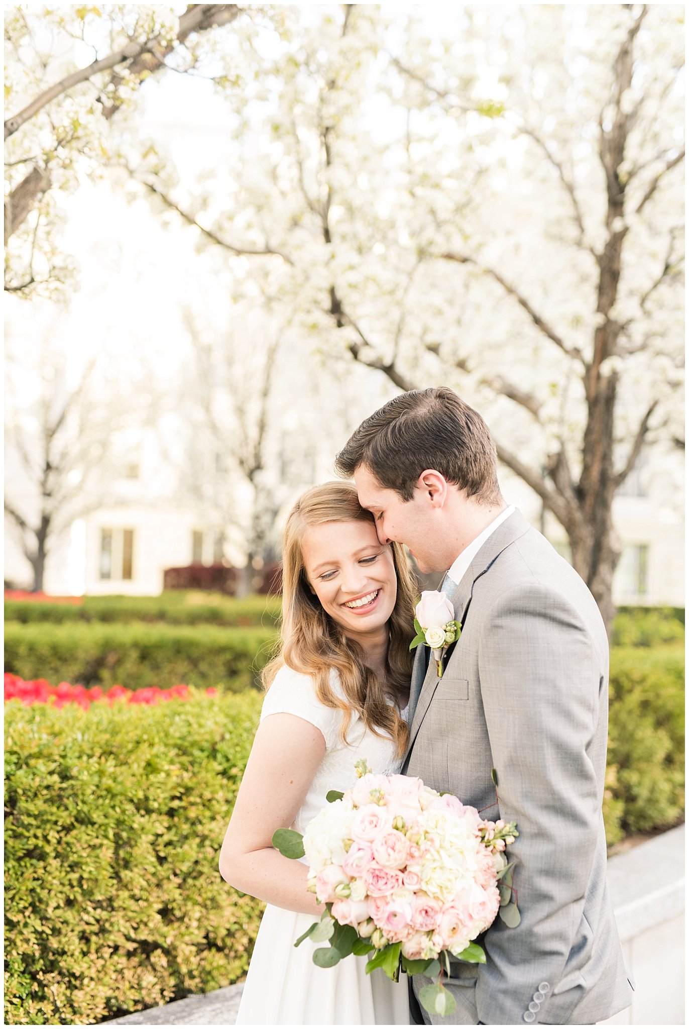 Bride with blush bouquet and groom with grey suit in the blossoms | Utah State Capitol Blossoms Formal Session | Salt Lake Wedding Photographers | Jessie and Dallin Photography