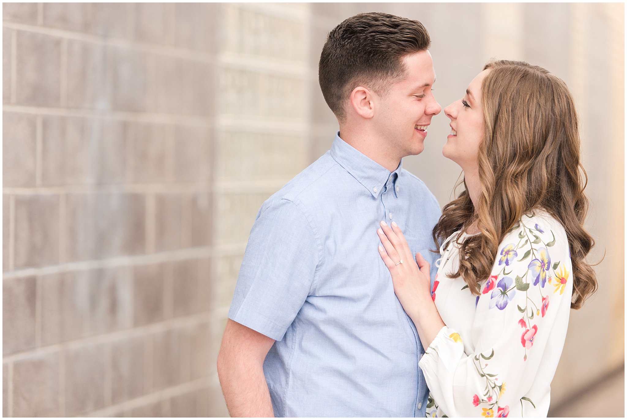 Couple dressed in elegant, light, neutral colors for downtown urban engagement in Logan Utah | Downtown Logan and Wellsville Mountain Engagement | Jessie and Dallin Photography