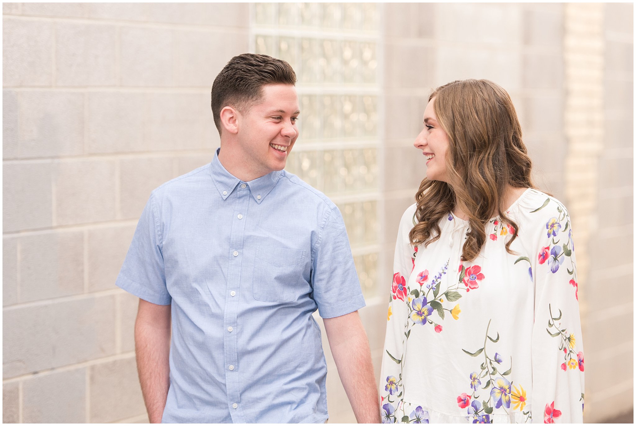 Couple dressed in elegant, light, neutral colors for downtown urban engagement in Logan Utah | Downtown Logan and Wellsville Mountain Engagement | Jessie and Dallin Photography