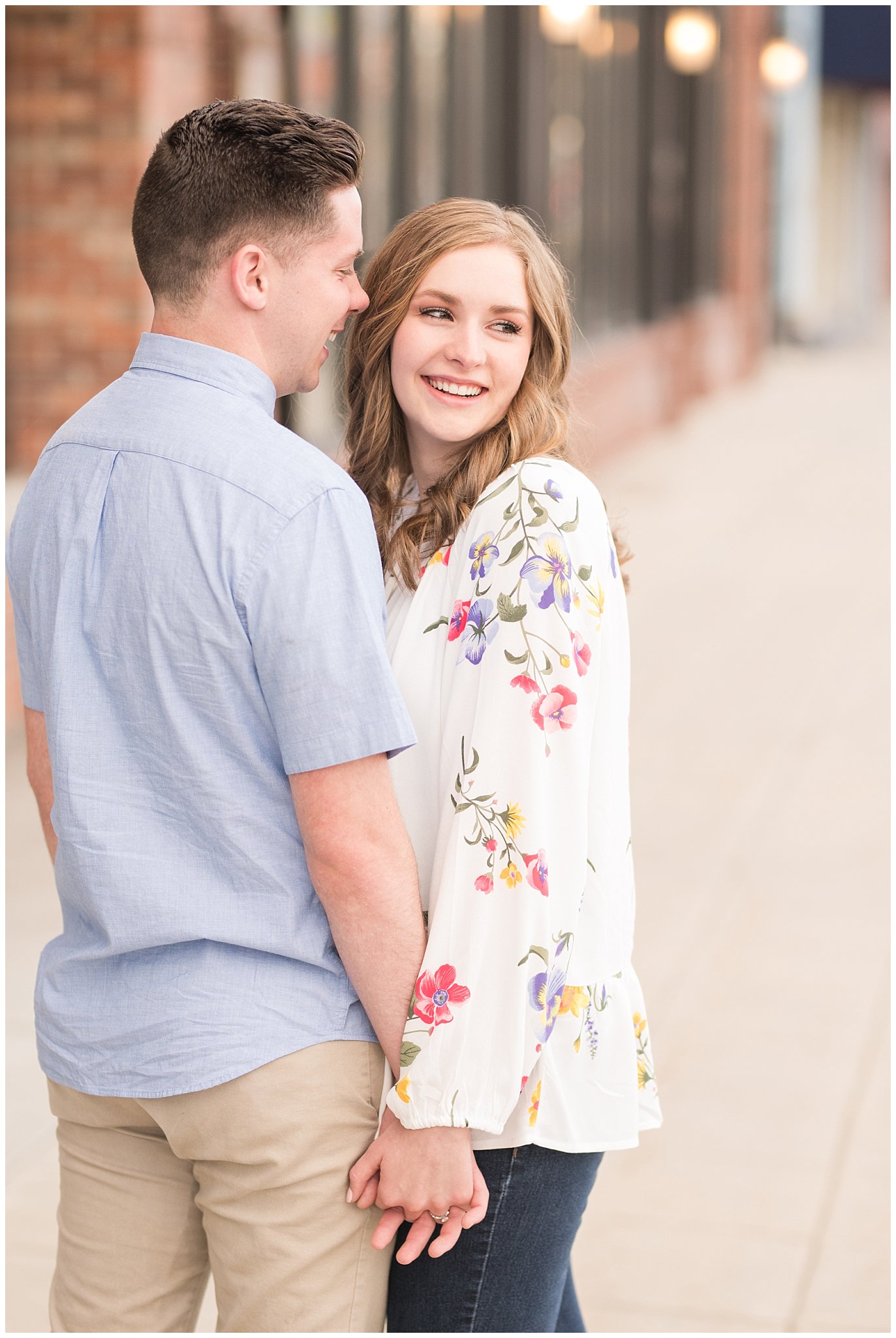 Couple dressed in elegant, light, neutral colors for downtown urban engagement in Logan Utah | Downtown Logan and Wellsville Mountain Engagement | Jessie and Dallin Photography