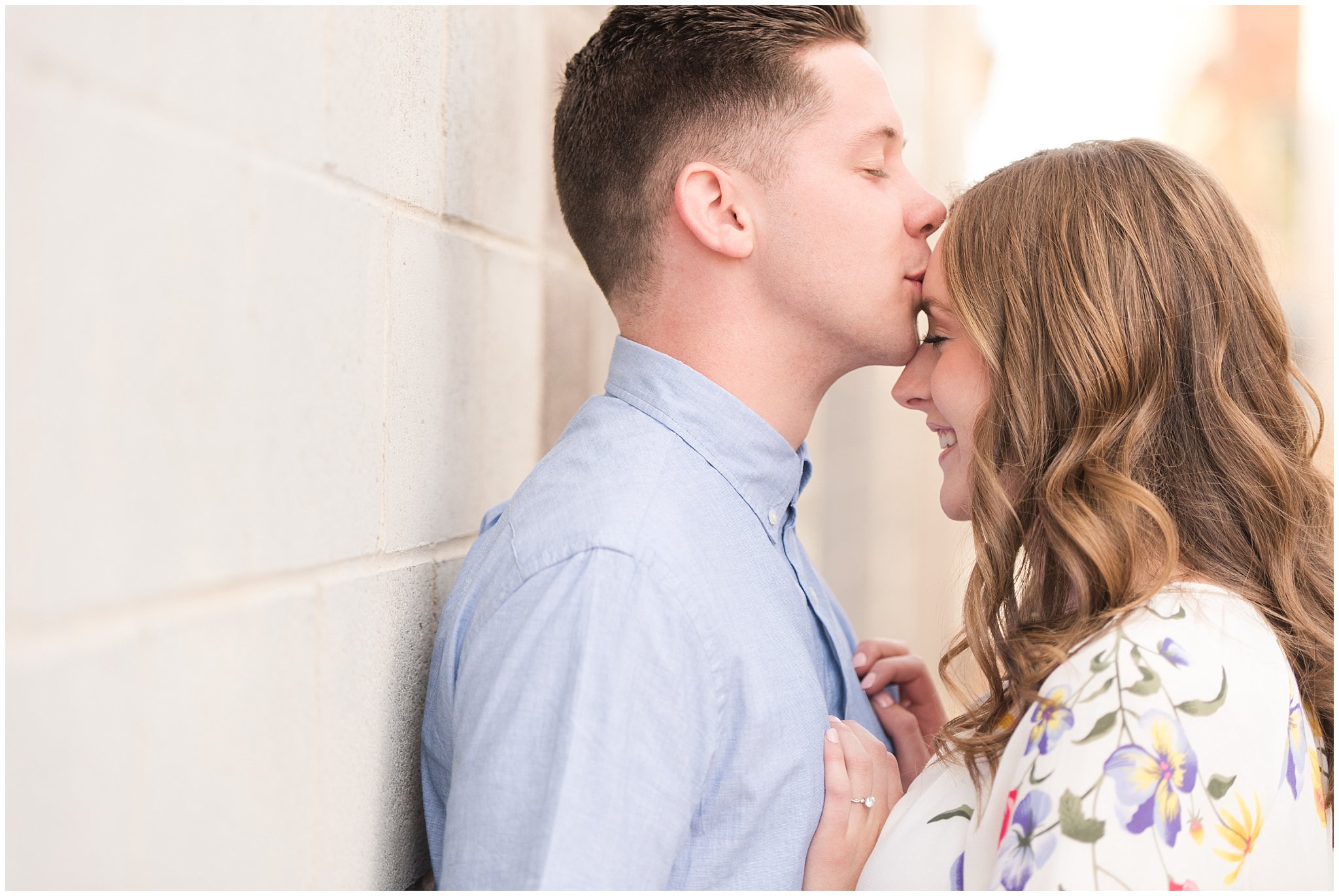 Couple dressed in elegant, light, neutral colors for downtown urban engagement in Logan Utah | Downtown Logan and Wellsville Mountain Engagement | Jessie and Dallin Photography