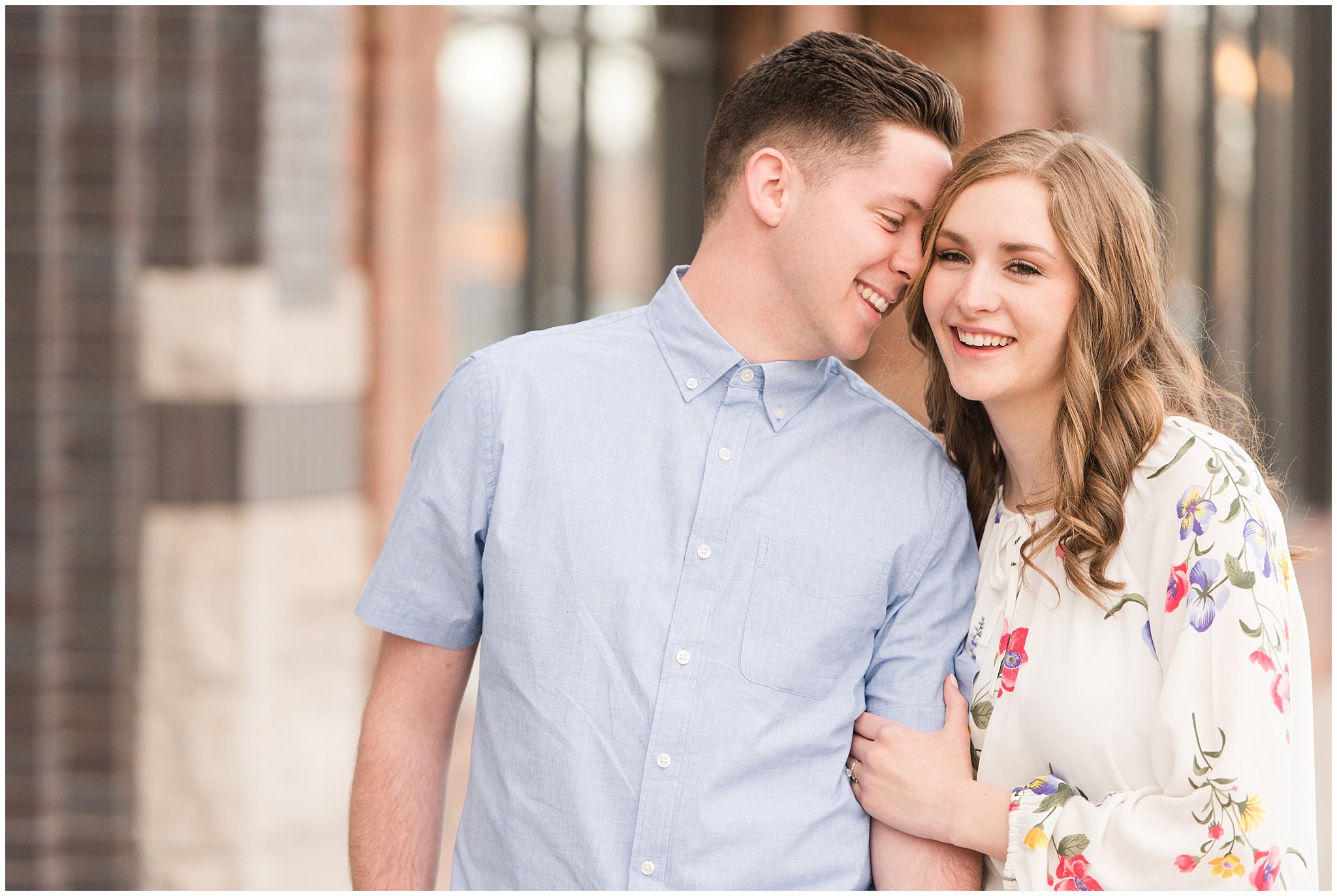 Couple dressed in elegant, light, neutral colors for downtown urban engagement in Logan Utah | Downtown Logan and Wellsville Mountain Engagement | Jessie and Dallin Photography