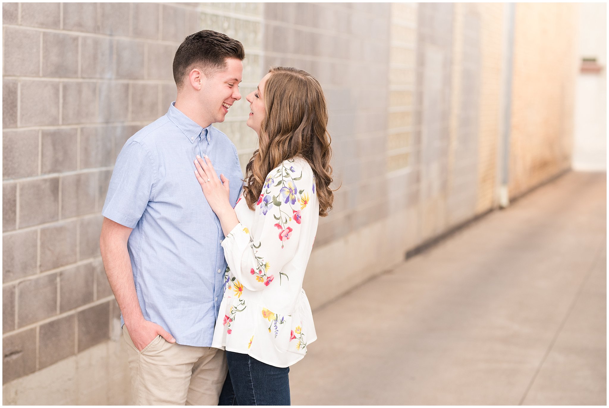 Couple dressed in elegant, light, neutral colors for downtown urban engagement in Logan Utah | Downtown Logan and Wellsville Mountain Engagement | Jessie and Dallin Photography