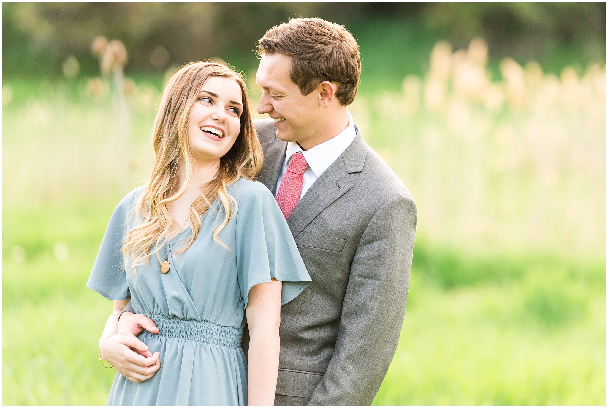 Couple dressed up in flowy blue dress and grey suit for engagement in the woods | Utah Engagement | Jessie and Dallin Photography