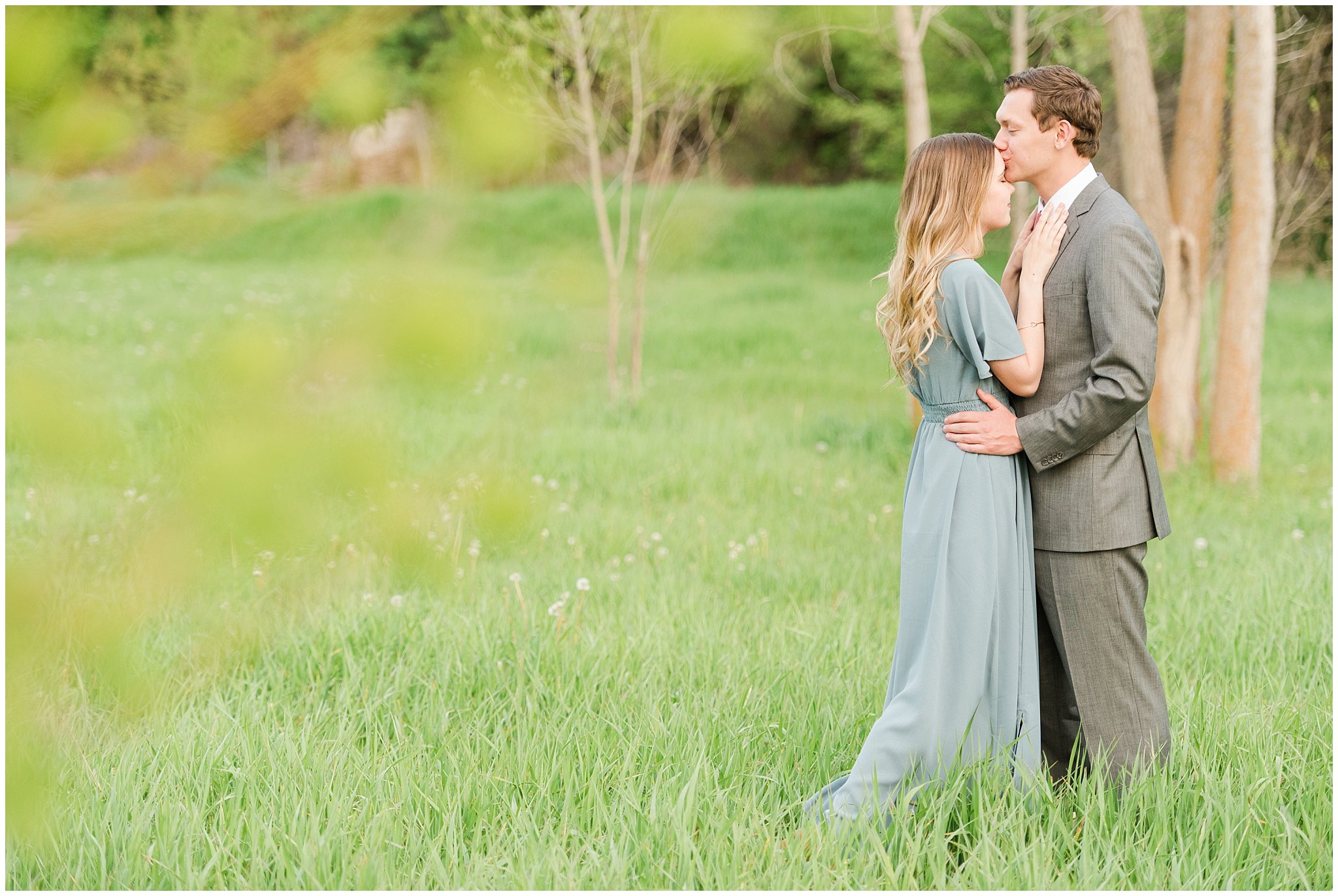 Couple dressed up in flowy blue dress and grey suit for engagement in the woods | Utah Engagement | Jessie and Dallin Photography