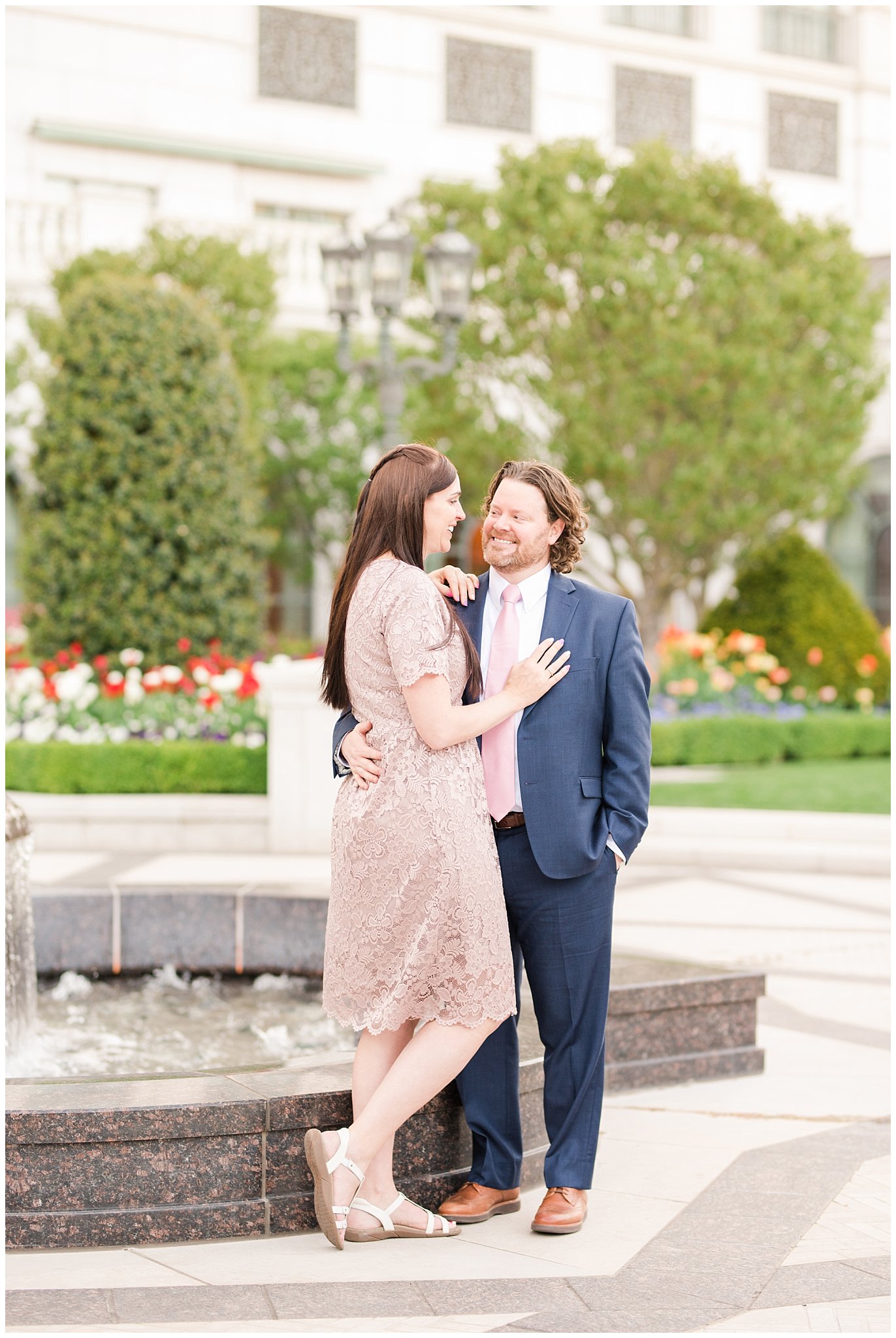 Couple in blue suit and blush dress outside at the Grand America Hotel | Sealing at the Salt Lake Temple and Grand America | Jessie and Dallin Photography