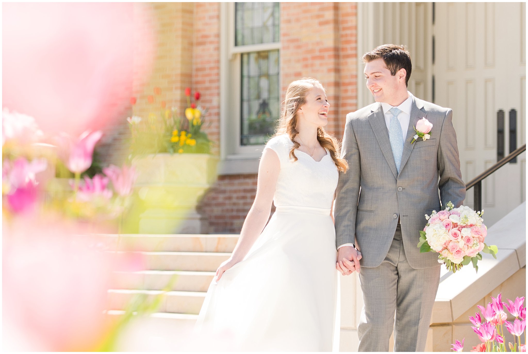 Bride and groom in tulips at Provo City Center temple with grey, blush, and light blue wedding colors | Spring Provo City Center Temple Wedding | Utah Wedding Photographers | Jessie and Dallin Photography