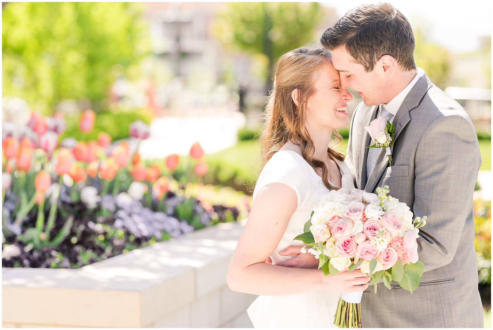 Bride and groom at Provo City Center temple with grey, blush, and light blue wedding colors | Spring Provo City Center Temple Wedding | Utah Wedding Photographers | Jessie and Dallin Photography