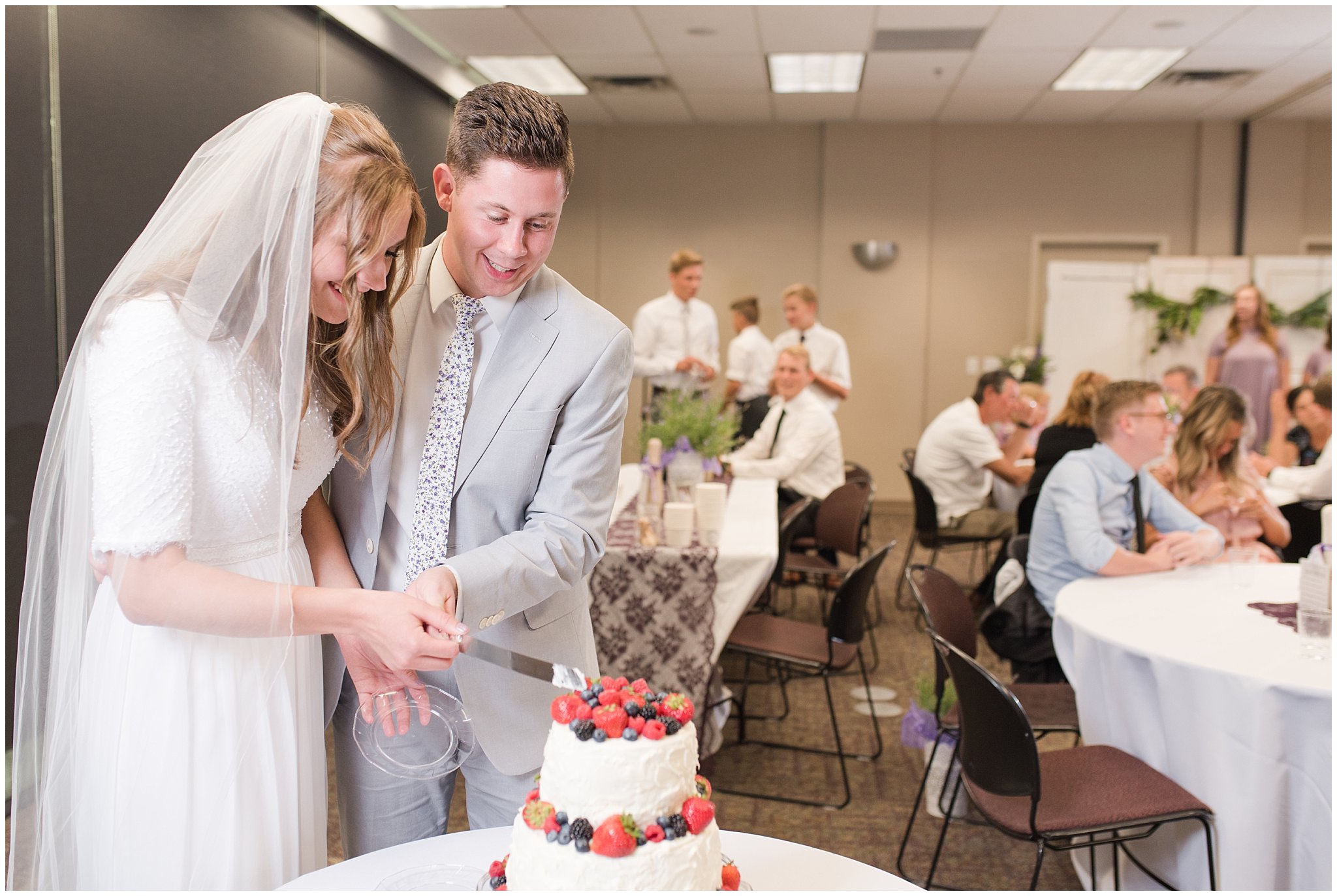Bride and groom cut berry wedding cake | Salt Lake Temple Wedding and Clearfield City Hall Reception | Utah Wedding Photographers | Jessie and Dallin Photography