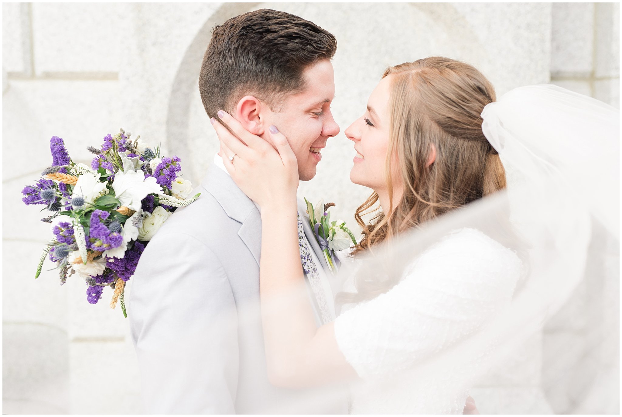 Bride and groom wearing elegant, simple dress with veil and grey suit with lavender florals | Elegant formal session at the Salt Lake Temple and Ensign Peak Formal Session | Jessie and Dallin Photography