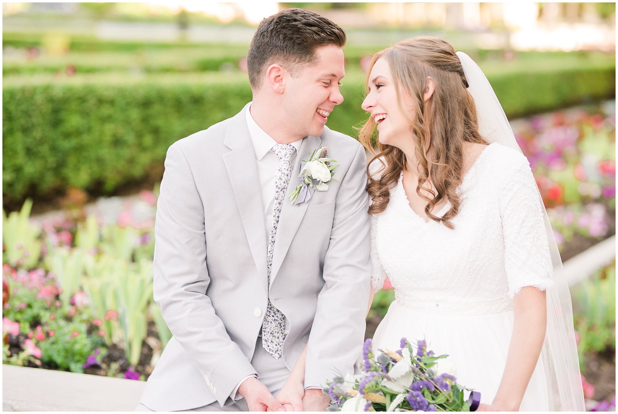 Bride and groom wearing elegant, simple dress with veil and grey suit with lavender florals | Elegant formal session at the Salt Lake Temple and Ensign Peak Formal Session | Jessie and Dallin Photography