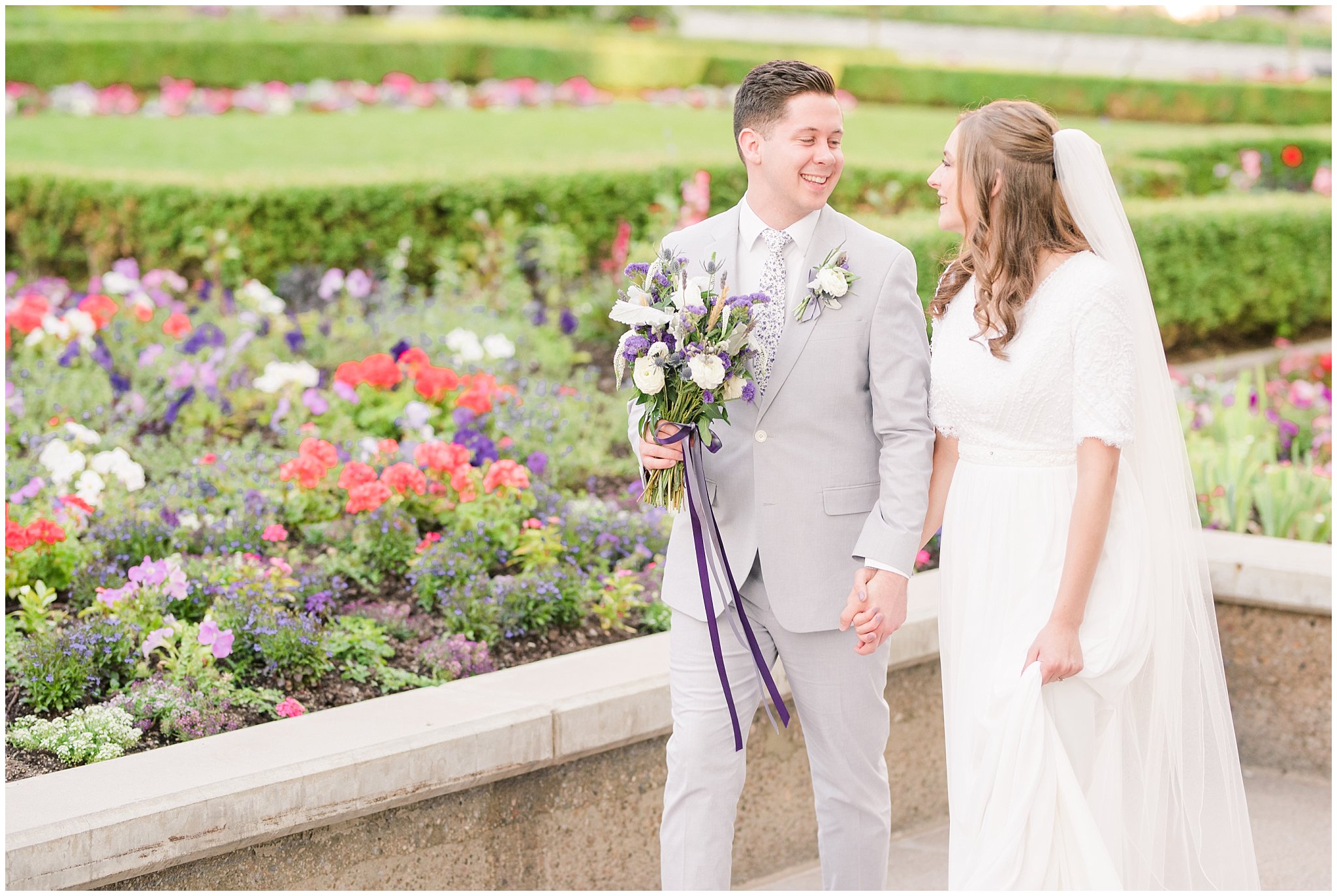 Bride and groom wearing elegant, simple dress with veil and grey suit with lavender florals | Elegant formal session at the Salt Lake Temple and Ensign Peak Formal Session | Jessie and Dallin Photography