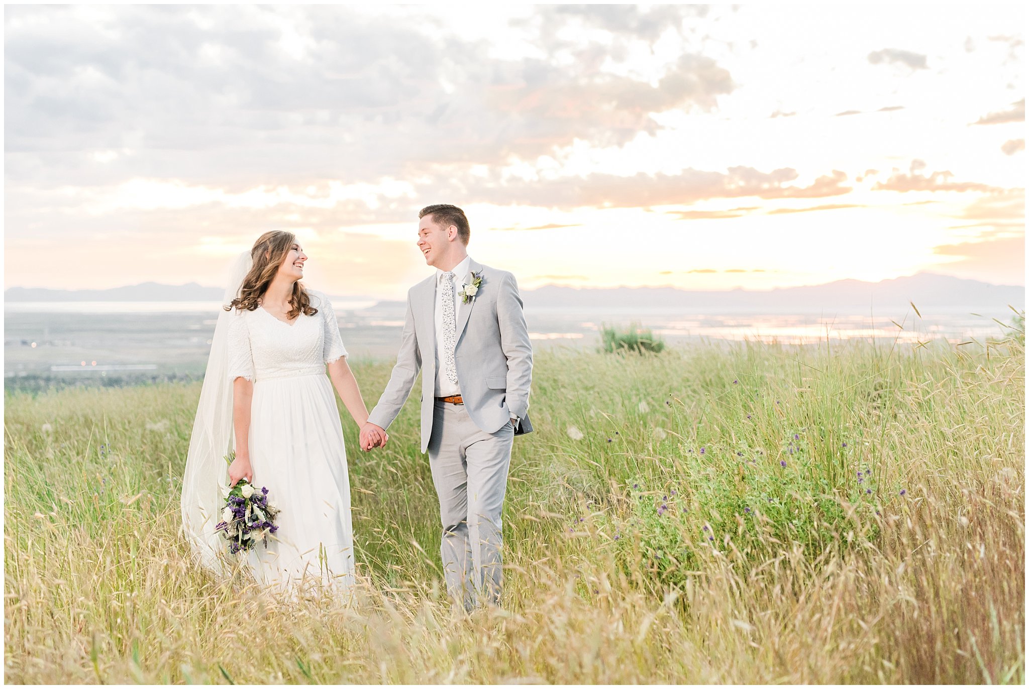 Bride and groom at sunset overlooking Salt Lake City | Wearing elegant, simple dress with veil and grey suit with lavender florals | Elegant formal session at the Salt Lake Temple and Ensign Peak Formal Session | Jessie and Dallin Photography