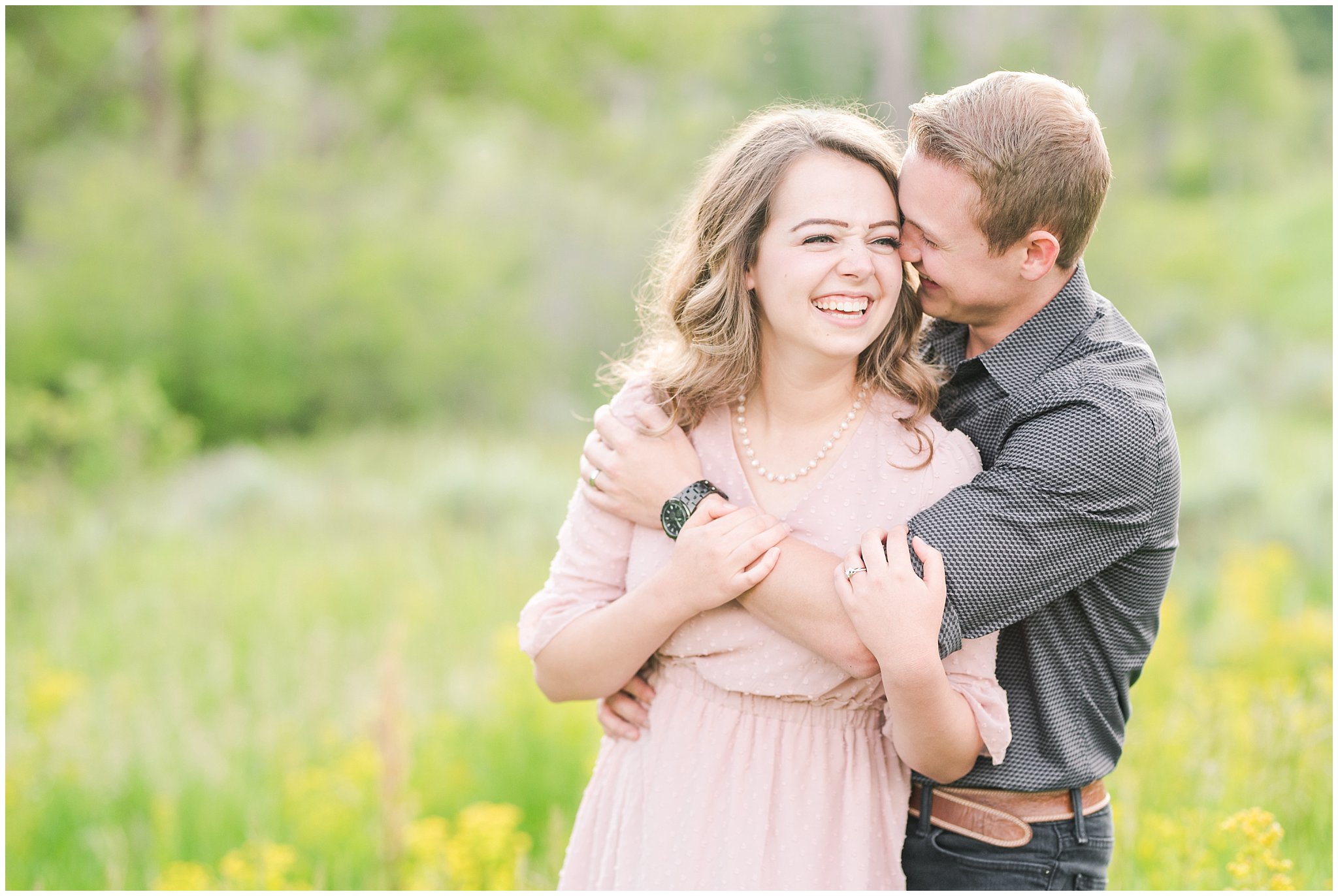 Couple in blush dress and grey and black buttoned shirt in a wooded meadow | Trapper's Loop Mountain Engagement | Utah Mountain Engagement Session | Jessie and Dallin Photography