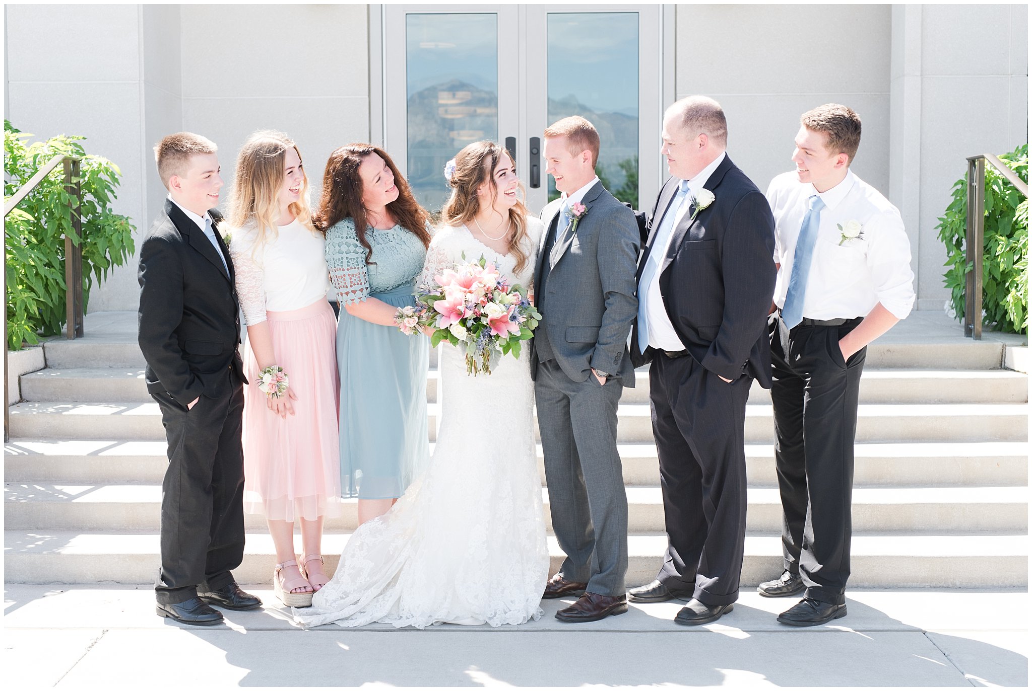 Bride with lace wedding dress and veil and groom wearing grey suit with light blue tie | Family portraits | Ogden Temple Summer Wedding | Jessie and Dallin Photography