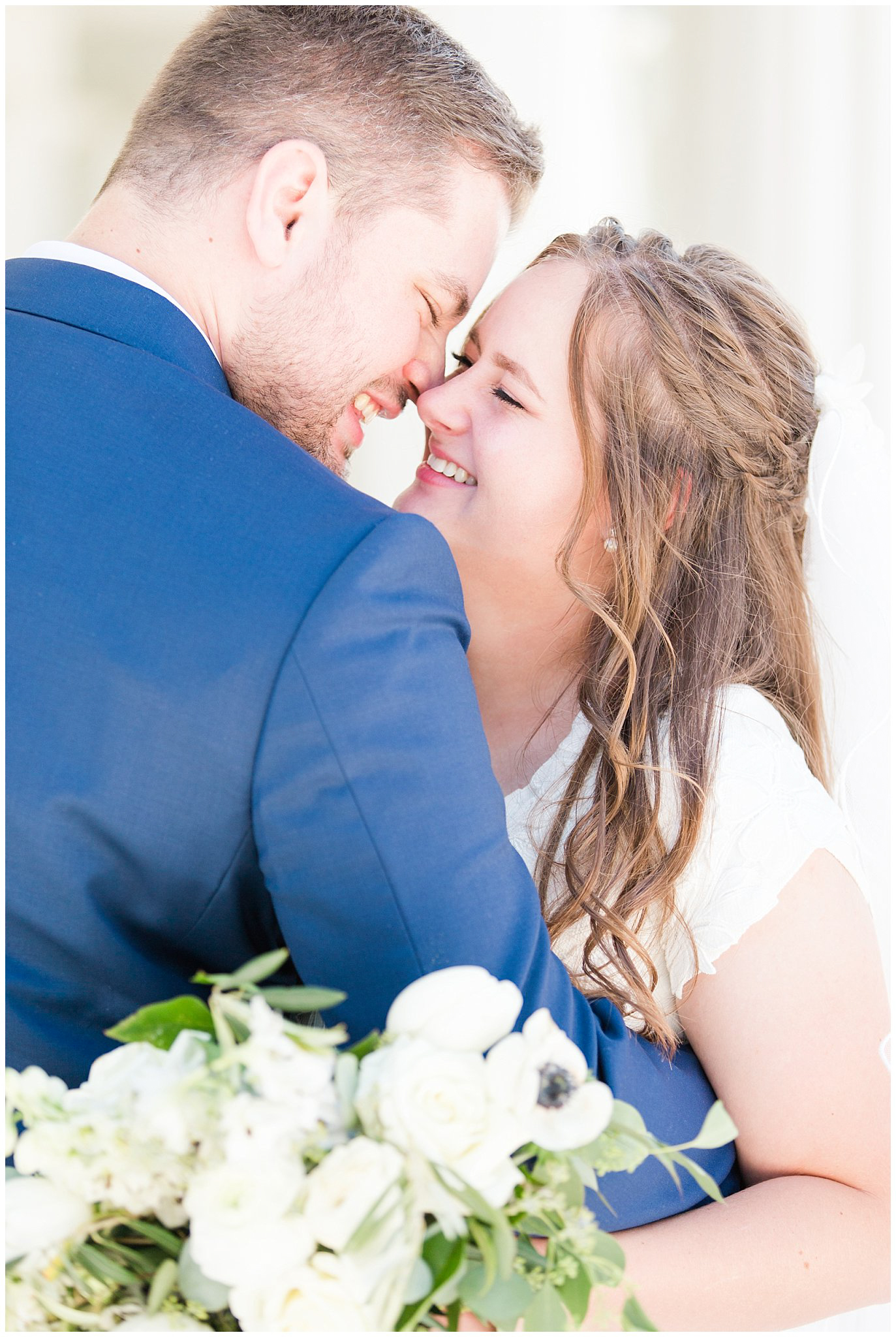 Bride in elegant lace dress, white anemones bouquet, and vintage veil and groom in navy suit with wine colored tie | Summer Bountiful Temple Wedding | Jessie and Dallin Photography