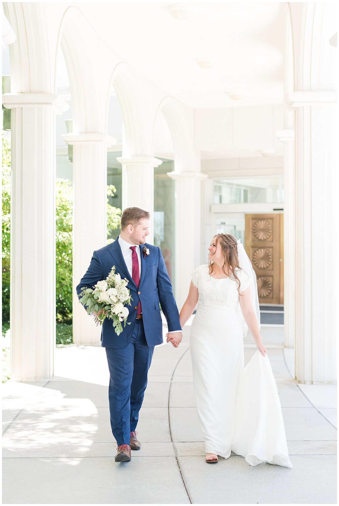 Bride in elegant lace dress, white anemones bouquet, and vintage veil and groom in navy suit with wine colored tie | Summer Bountiful Temple Wedding | Jessie and Dallin Photography