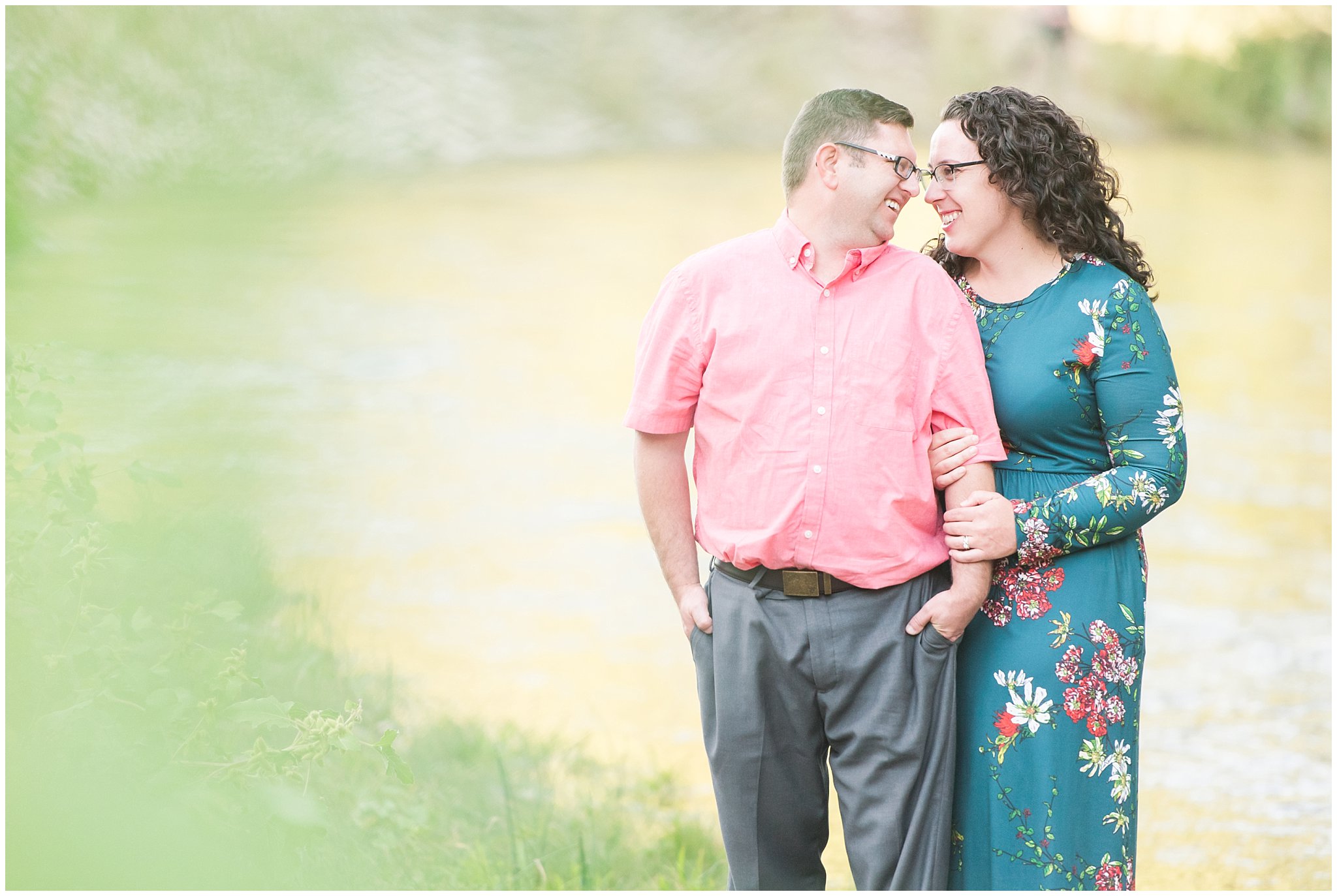 Couple in blue green floral dress and pink shirt by the Ogden river | Fort Buenaventura Summer Engagement Session | Jessie and Dallin Photography