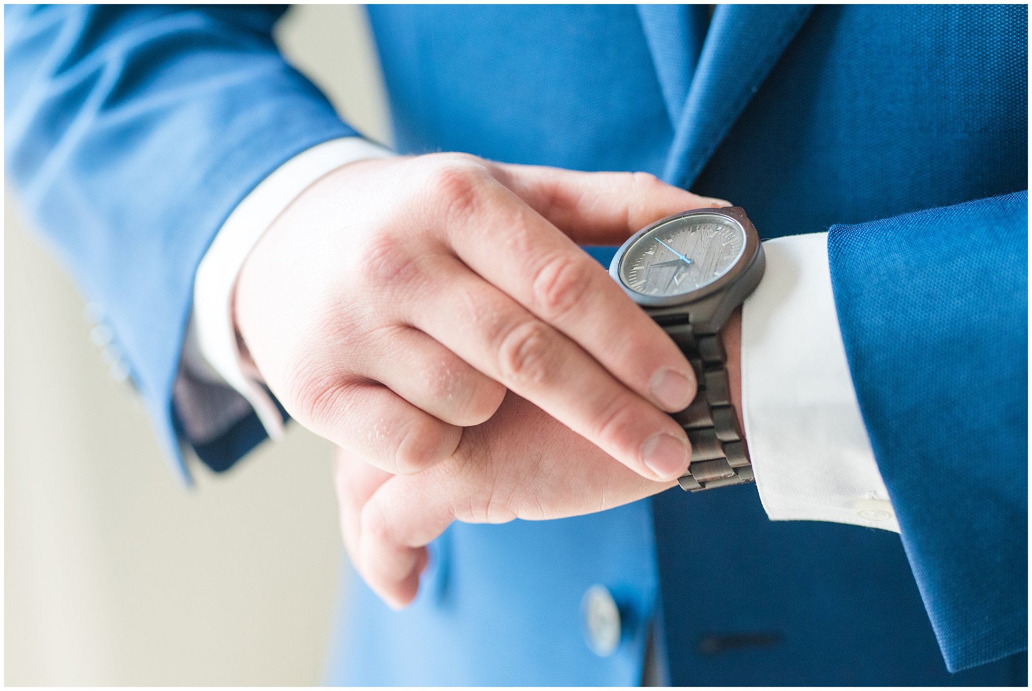 Groom in cornish blue suit adjusting watch | Log Haven Summer Mountain Wedding | Jessie and Dallin Photography