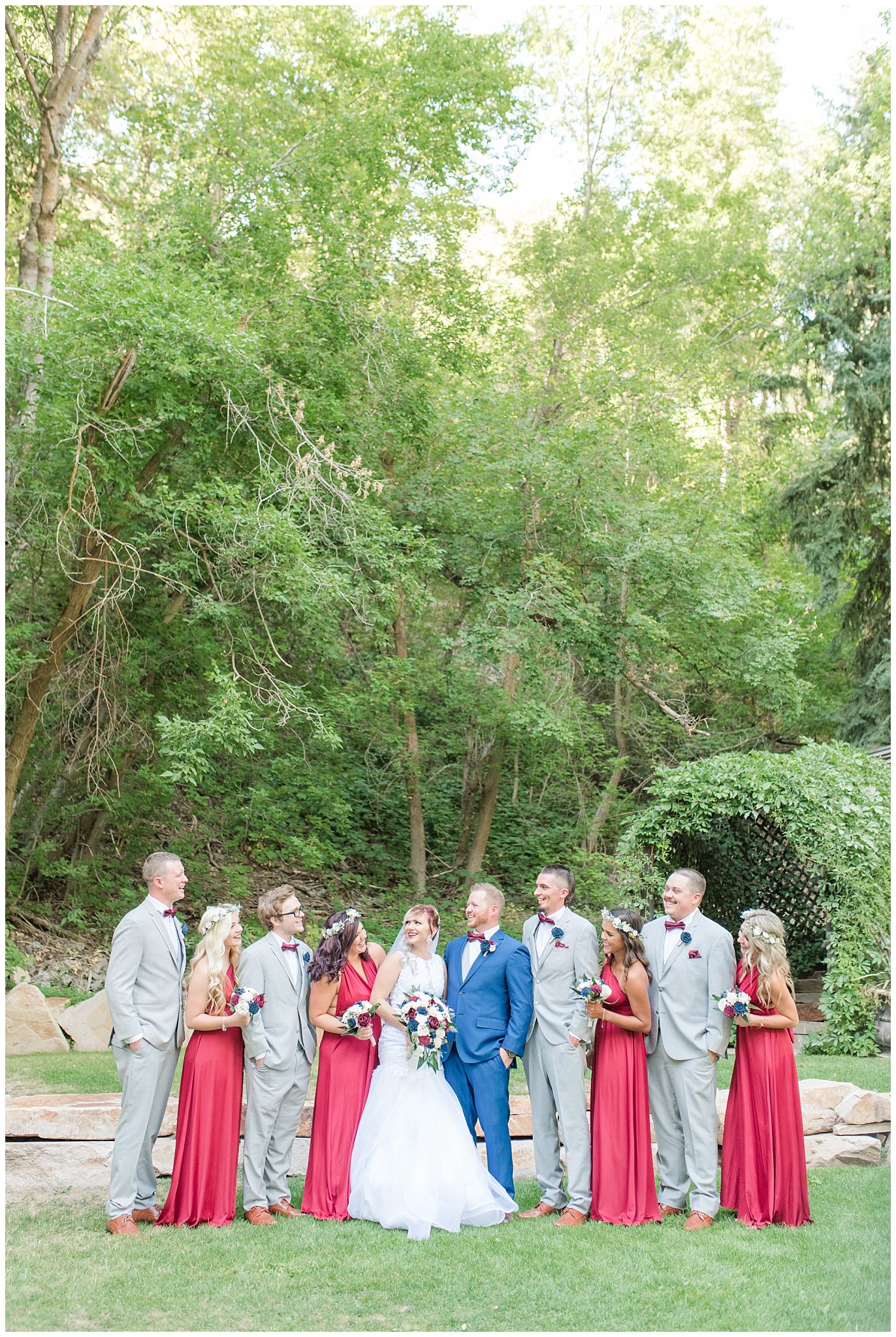 Bridal party with bridesmaids in burgundy dresses and groomsmen in grey suits and groom in cornish blue suit with burgundy bow ties | Log Haven Summer Mountain Wedding | Jessie and Dallin Photography