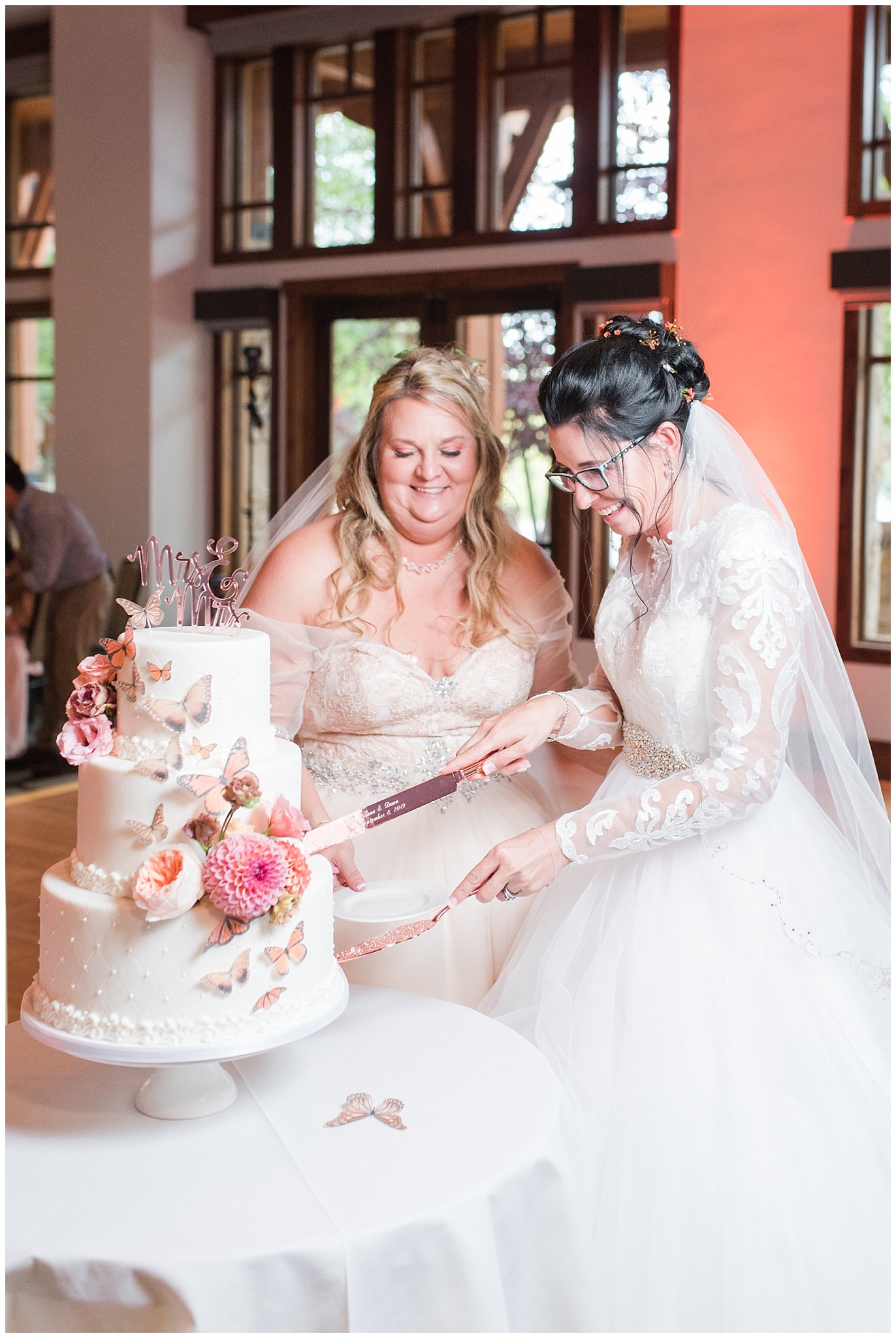 White wedding cake with butterflies and sunset colors of pink and orange | Park City Wedding at the Hyatt Centric | Jessie and Dallin Photography
