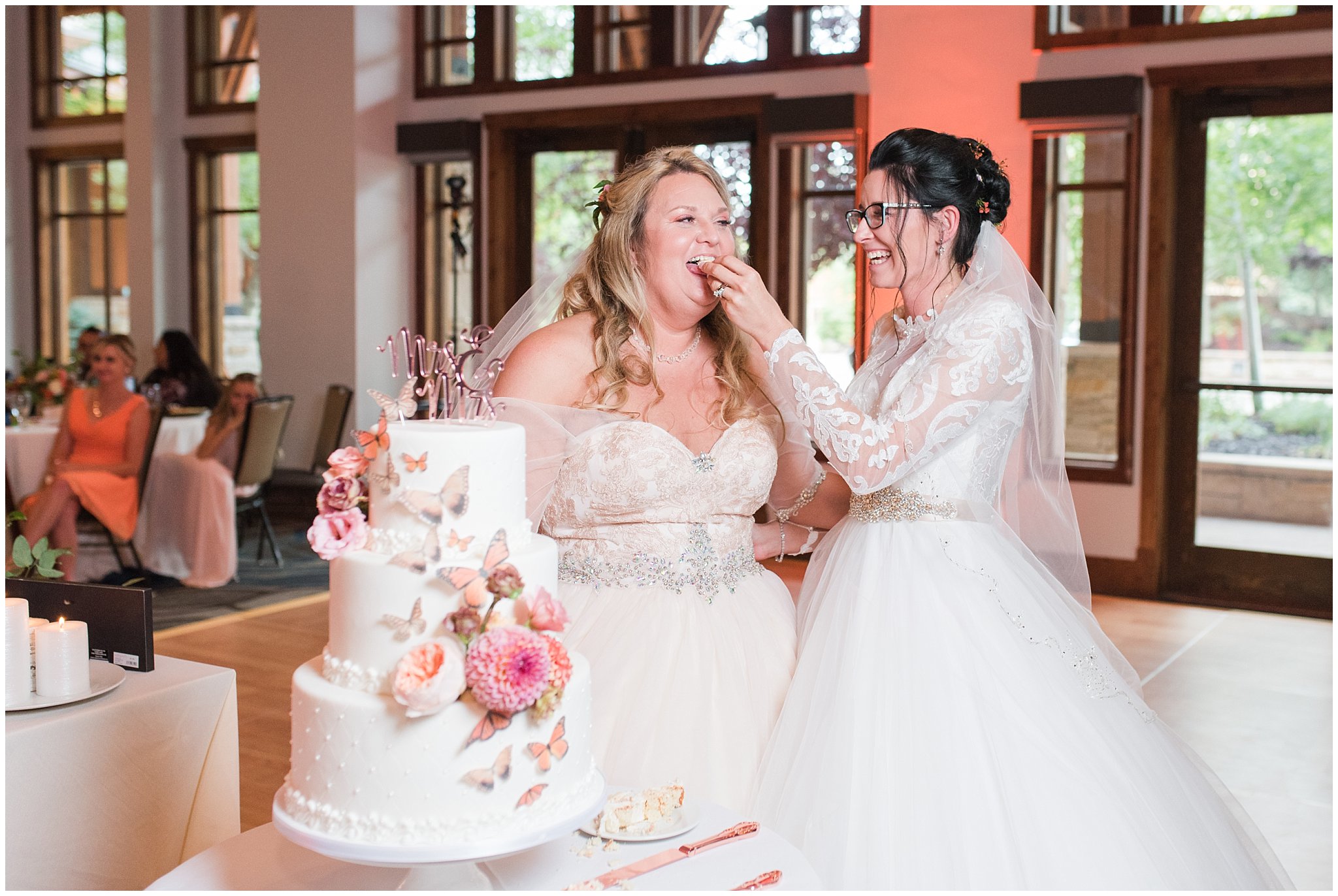 White wedding cake with butterflies and sunset colors of pink and orange | Park City Wedding at the Hyatt Centric | Jessie and Dallin Photography