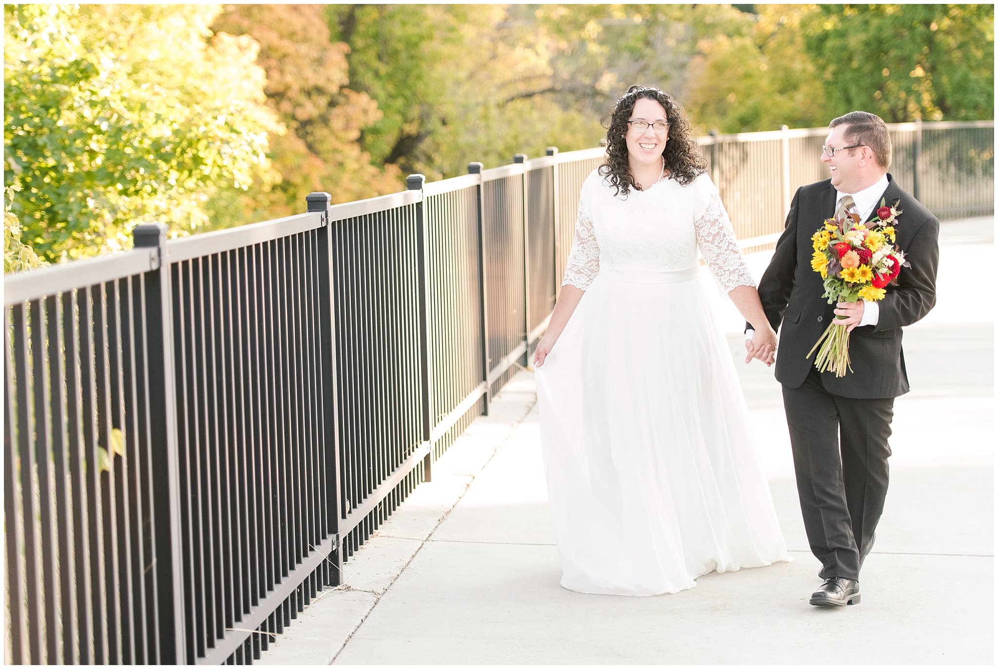 Groom in black suit and gold tie, bride in simple lace sleeve wedding dress with fall bouquet | Logan Temple Fall Formal Session | Jessie and Dallin Photography