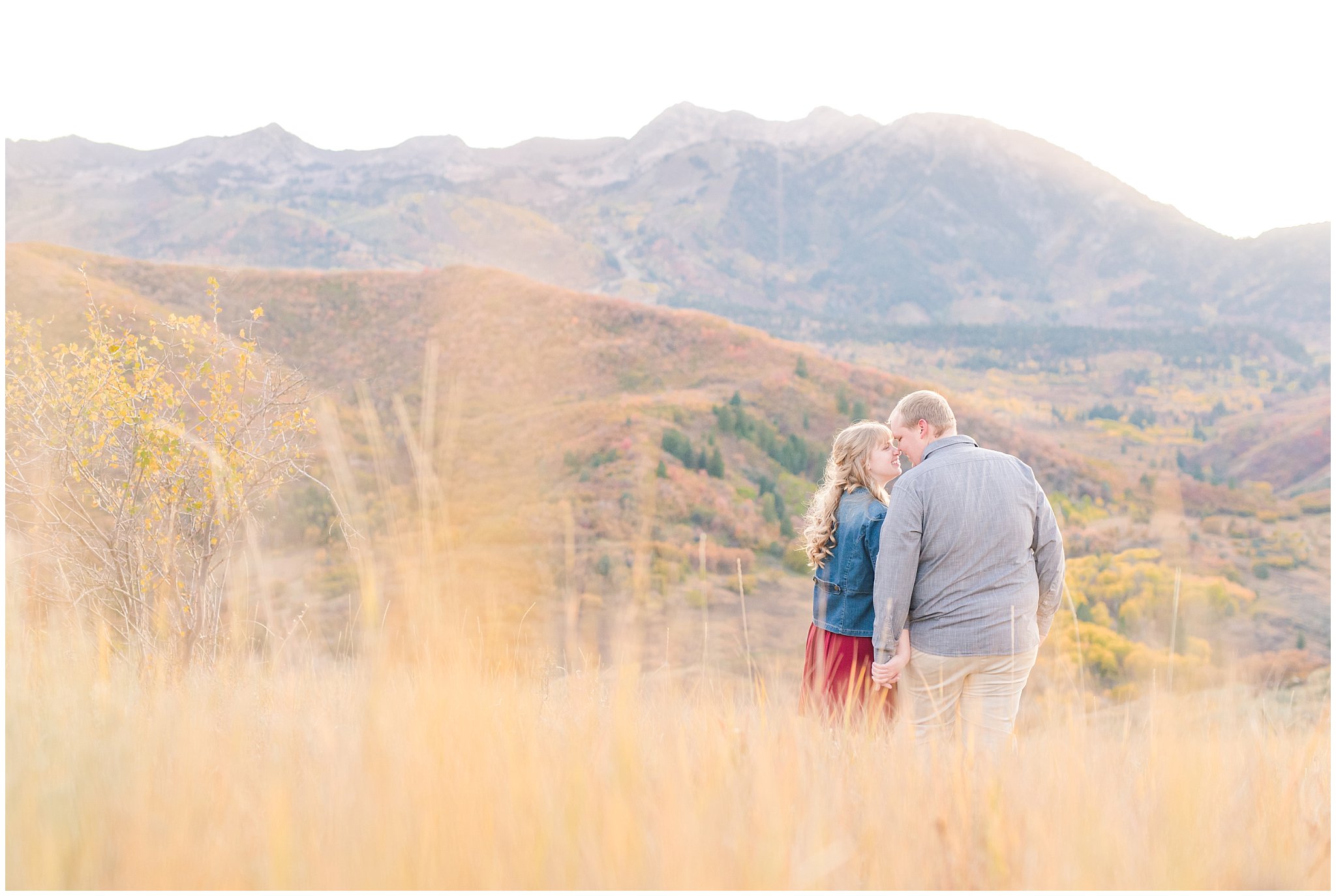 Couple dressed up with girl in burgundy dress with jean jacket and guy in grey shirt and light colored pants | Mountain engagement | Trapper's Loop Fall Engagement Session | Snowbasin Utah Mountains | Jessie and Dallin Photography