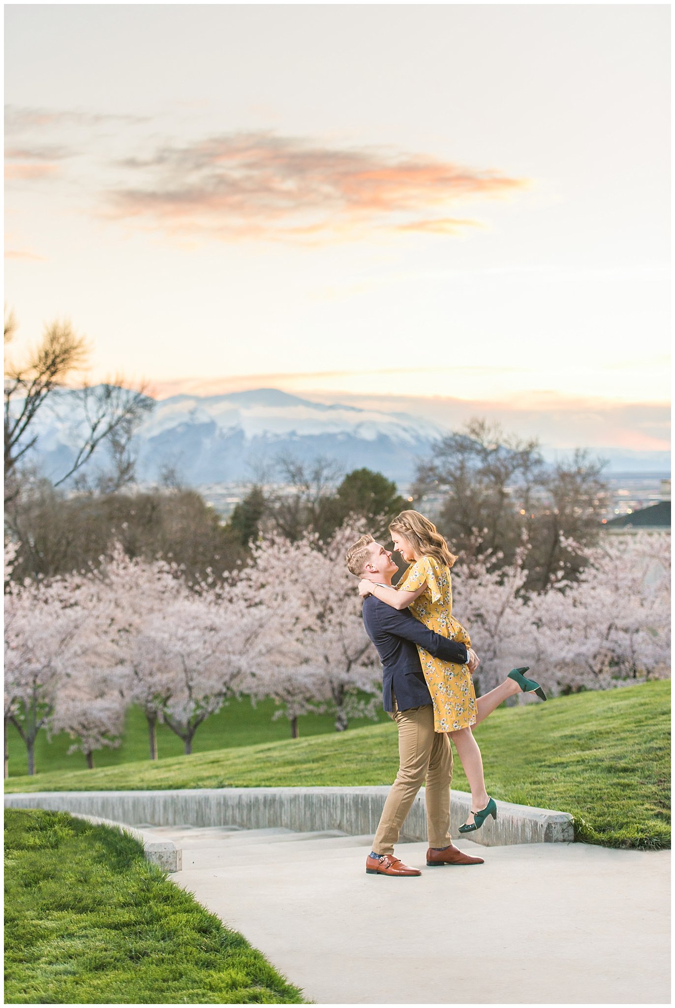 Couple does romantic lift at sunset in front of cherry blossoms at the Utah State Capitol building | Top Utah Wedding and Couples Photos 2019 | Jessie and Dallin Photography