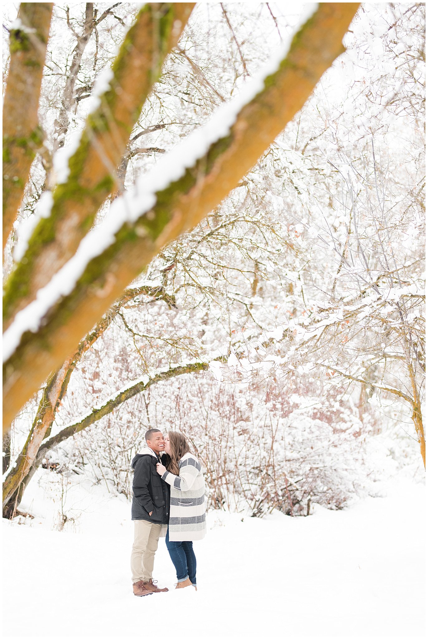 Engagement photos with a couple in the snowy winter Utah mountains with pine trees | Mueller Park and Downtown Winter Engagement Session | Jessie and Dallin Photography