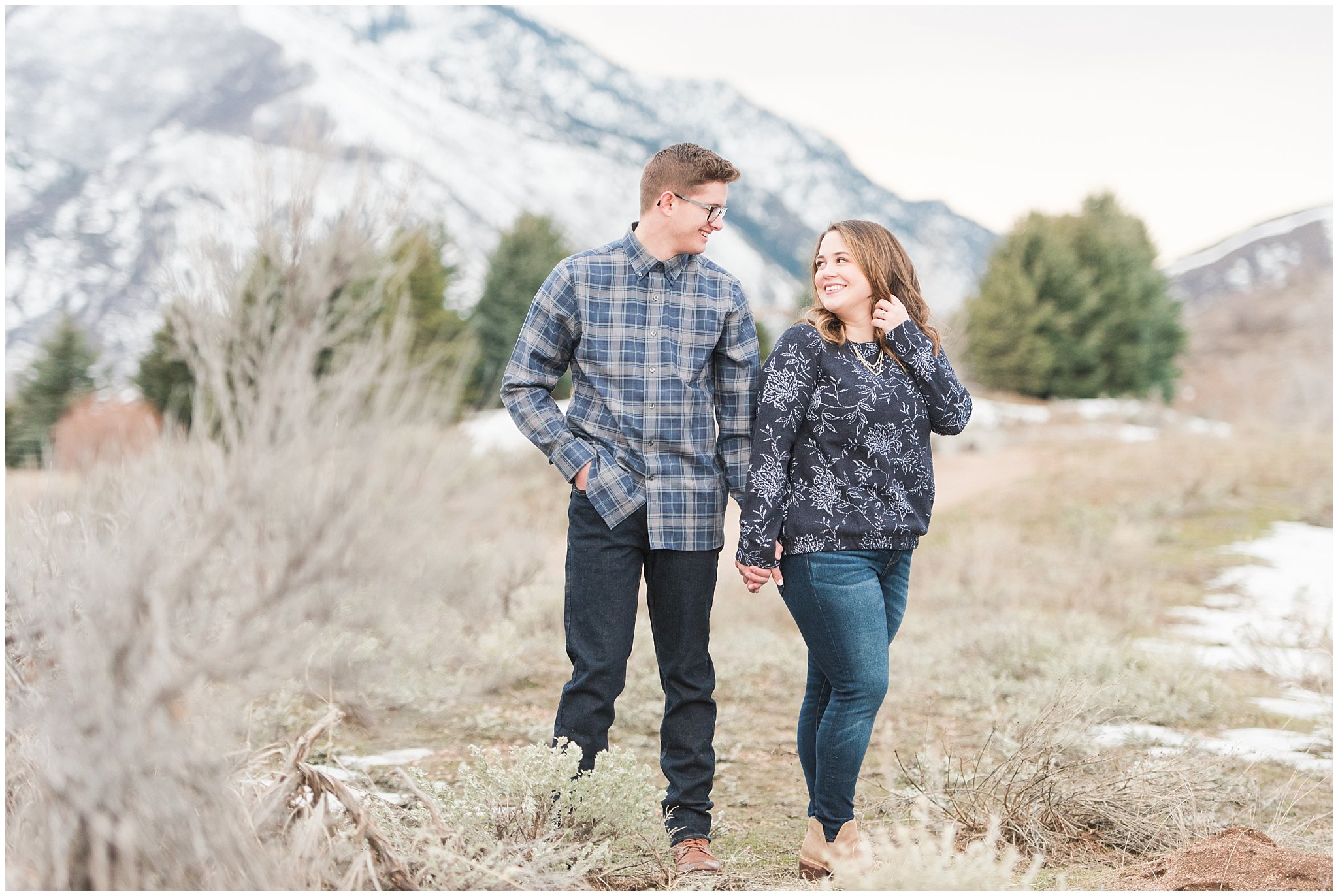 Couple in navy and grey casual outfits during winter mountain engagements | Trapper's Loop Winter Engagement | Jessie and Dallin Photography