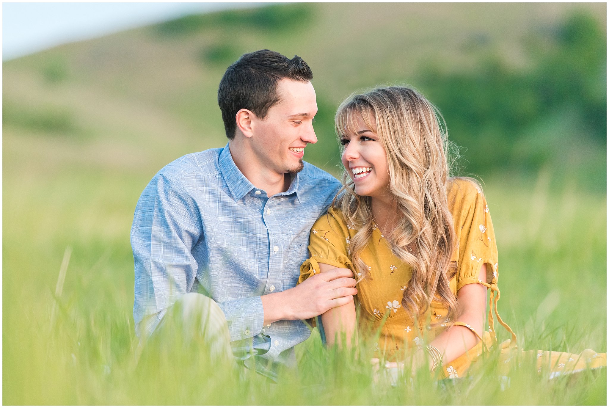 Couple in yellow dress and blue button up shirt on a grassy mountainside at Tunnel Springs | Utah State Capitol and Tunnel Springs Engagement Session | Jessie and Dallin Photography