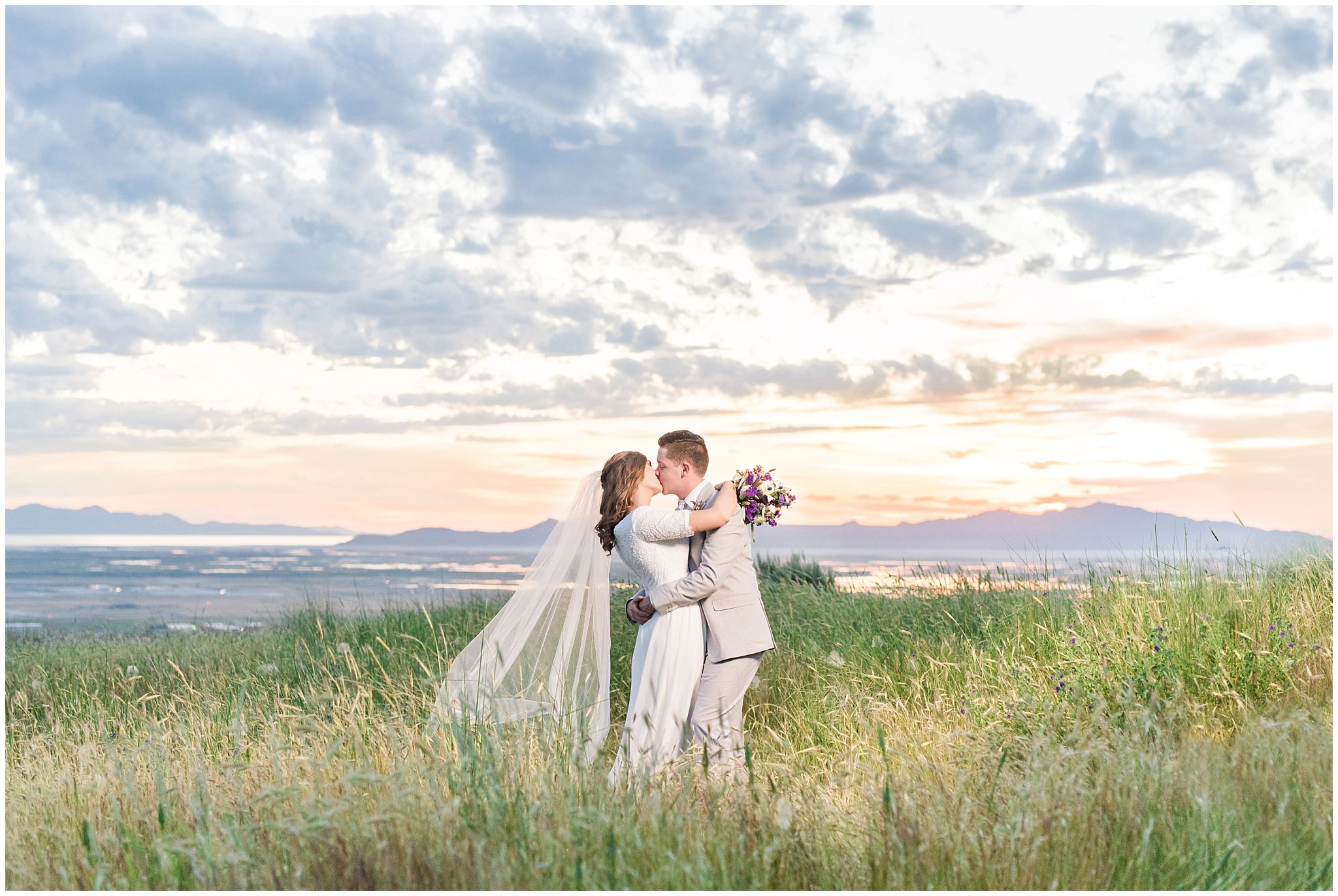 Bride and Groom in grassy field surrounded by sunset | Why a Wedding Veil Could be Your Favorite Wedding Detail and What to look for | Jessie and Dallin Photography